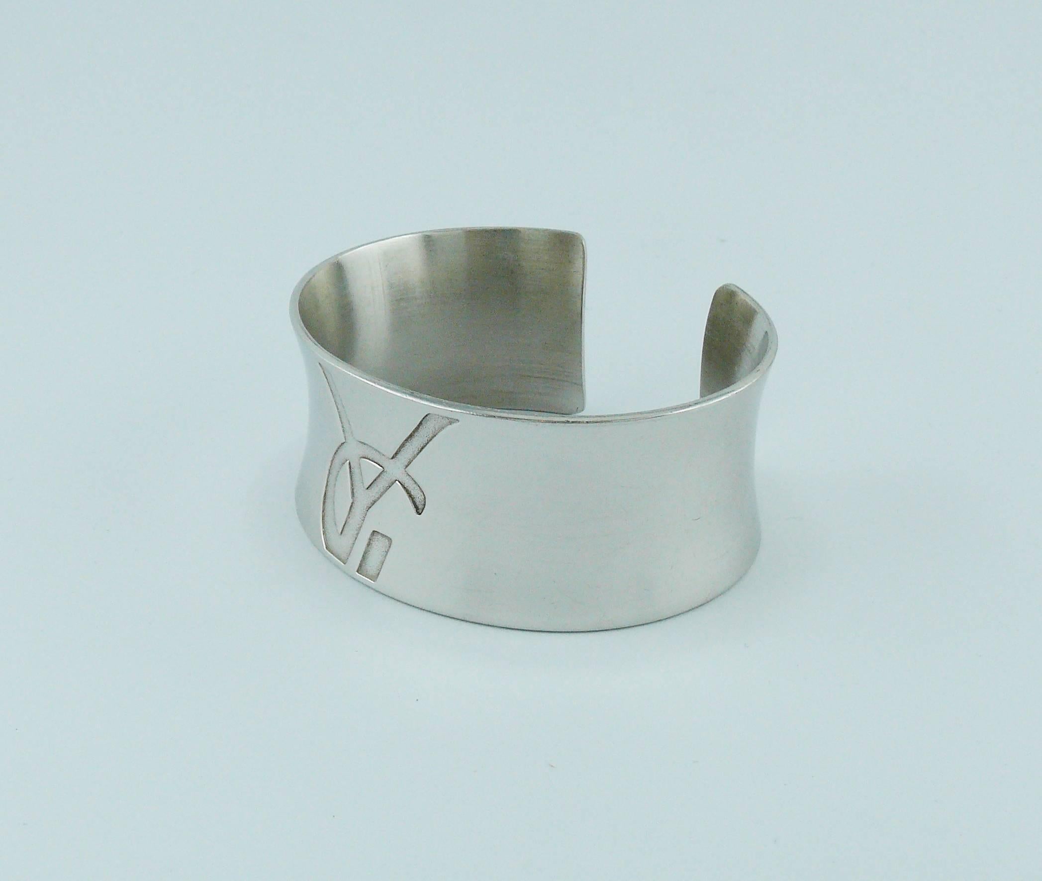 YVES SAINT LAURENT vintage sterling silver cuff bracelet embossed with YSL monogram at front.

French silver hallmark 