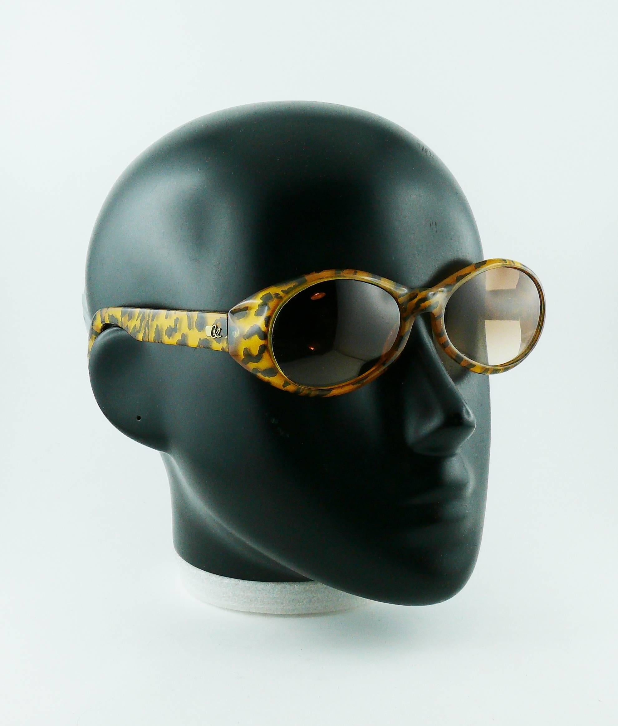 **** WE NO LONGER SHIP SUNGLASSES TO THE USA ****

CHRISTIAN LACROIX vintage sunglasses featuring a leopard print design.

Tinted lenses.
Gold tone detailing. 

Marked CHRISTIAN LACROIX.
OPTYL Made in Austria.
7329 40.

Indicative measurements :