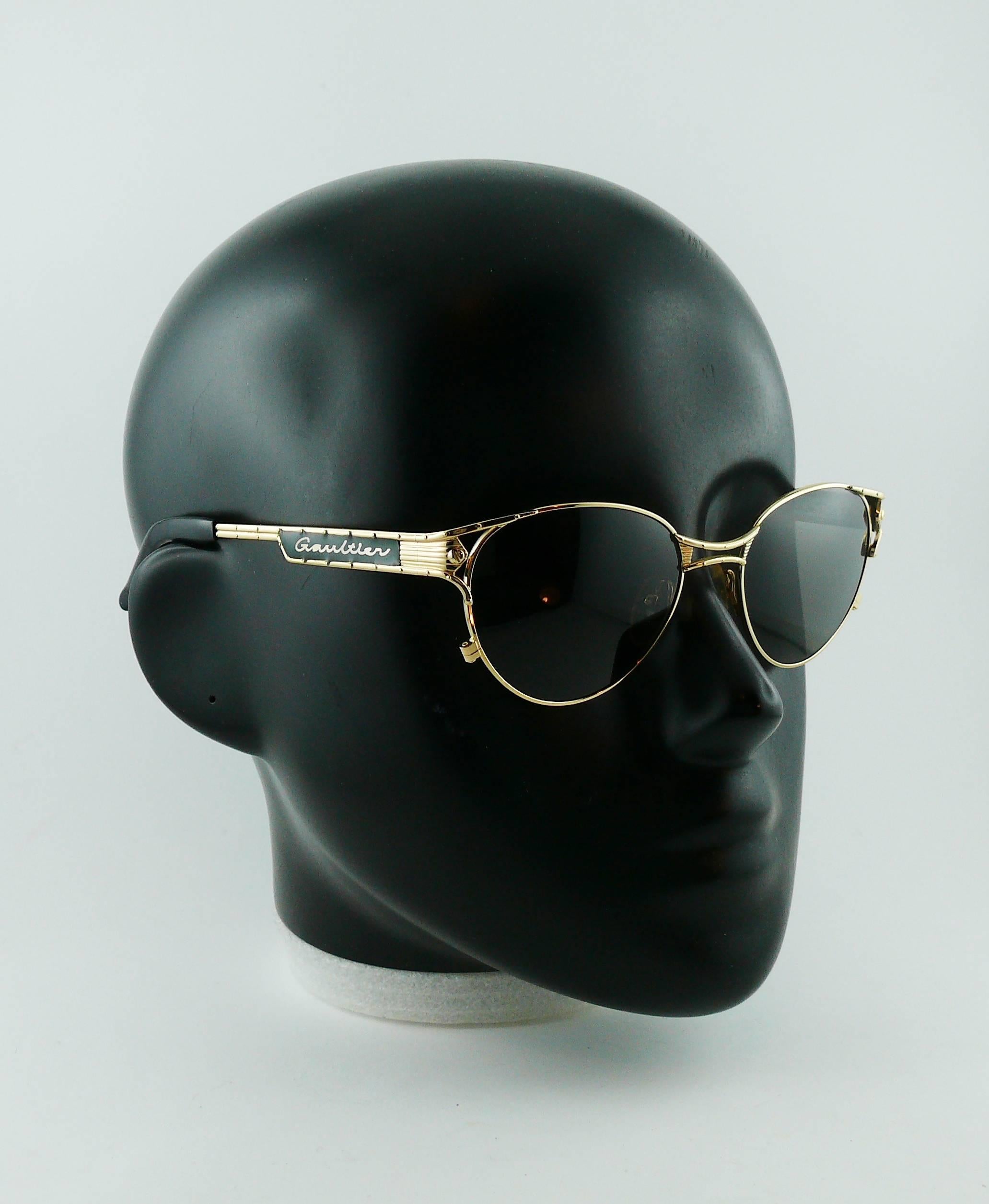 JEAN PAUL GAULTIER vintage 1990s sunglasses.

Gold toned frames with rivets details and green resin inlaid featuring 