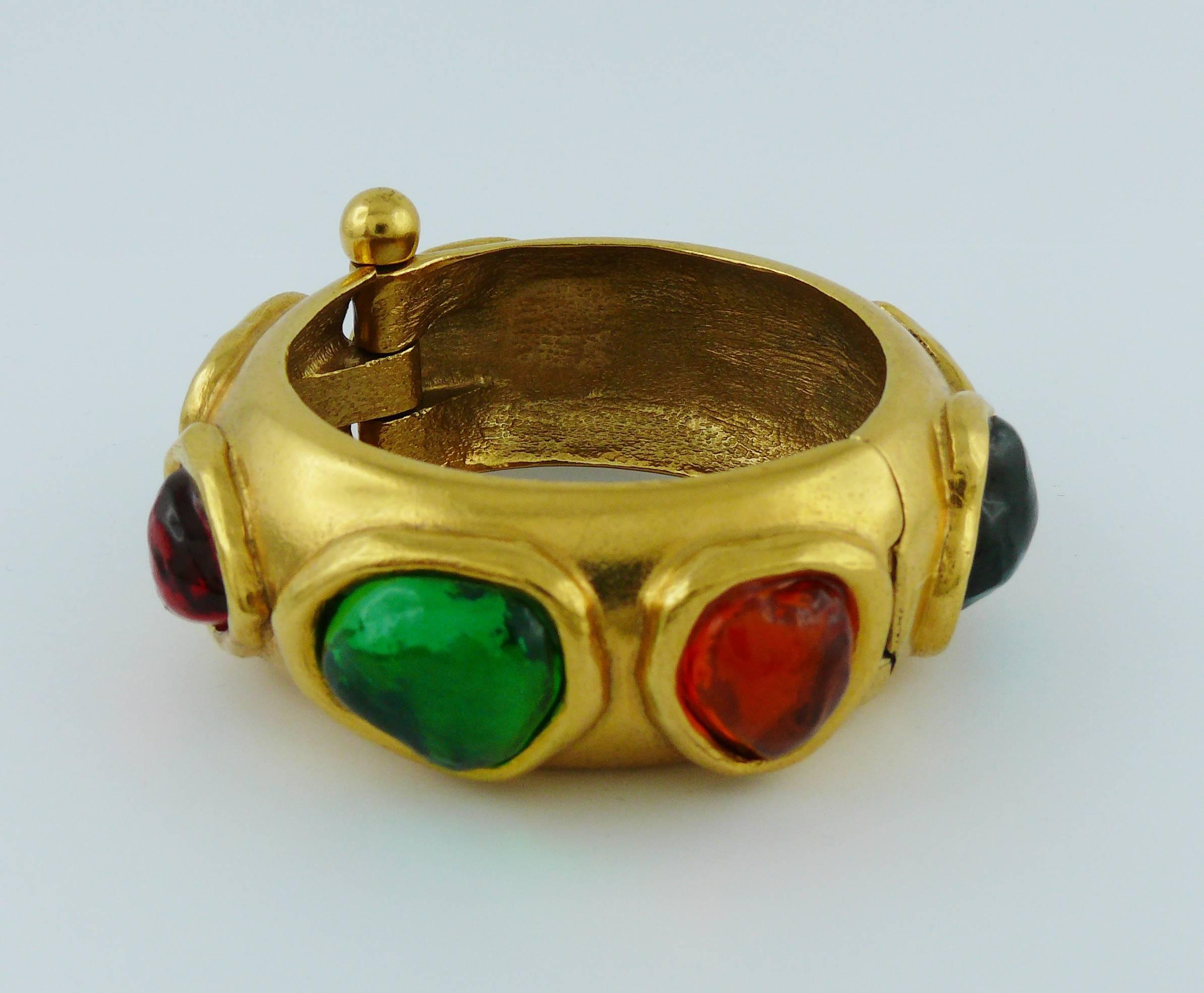 YVES SAINT LAURENT vintage cuff bracelet featuring large multicolored faux gemstone resin cabochons in a gold toned setting.

Embossed YSL Made in France.

Indicative measurements : inner circumference approx. 18.22 cm (7.17 inches) / width approx.