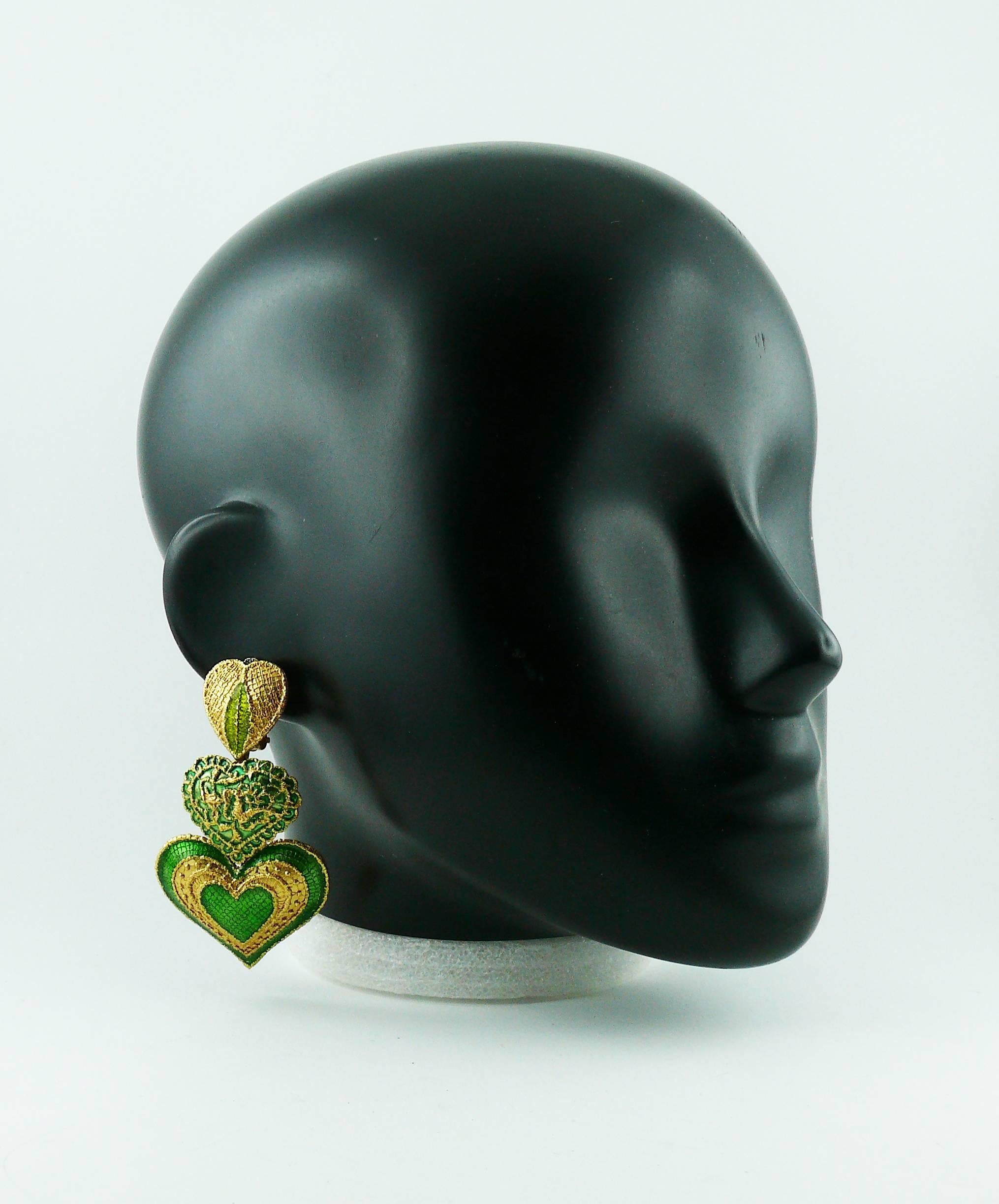 YVES SAINT LAURENT vintage dangling earrings (clip-on) featuring gold toned enamel hearts with a "lace-like" design.

Embossed YSL Made in France.

Indicative measurements : height approx. 7.5 cm (2.95 inches) / max. width approx. 4.2 cm