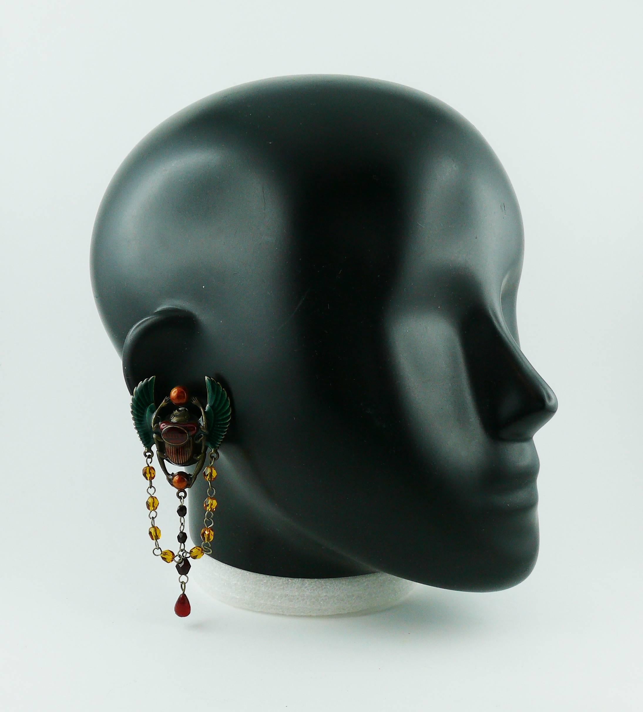 JEAN PAUL GAULTIER 1990s gorgeous clip-on earrings featuring enameled scarab beetle in a gun patina metal setting with glass bead chains.

GAULTIER logo at center.

Indicative measurements : max. height approx. 8.6 cm (3.39 inches) / max. width