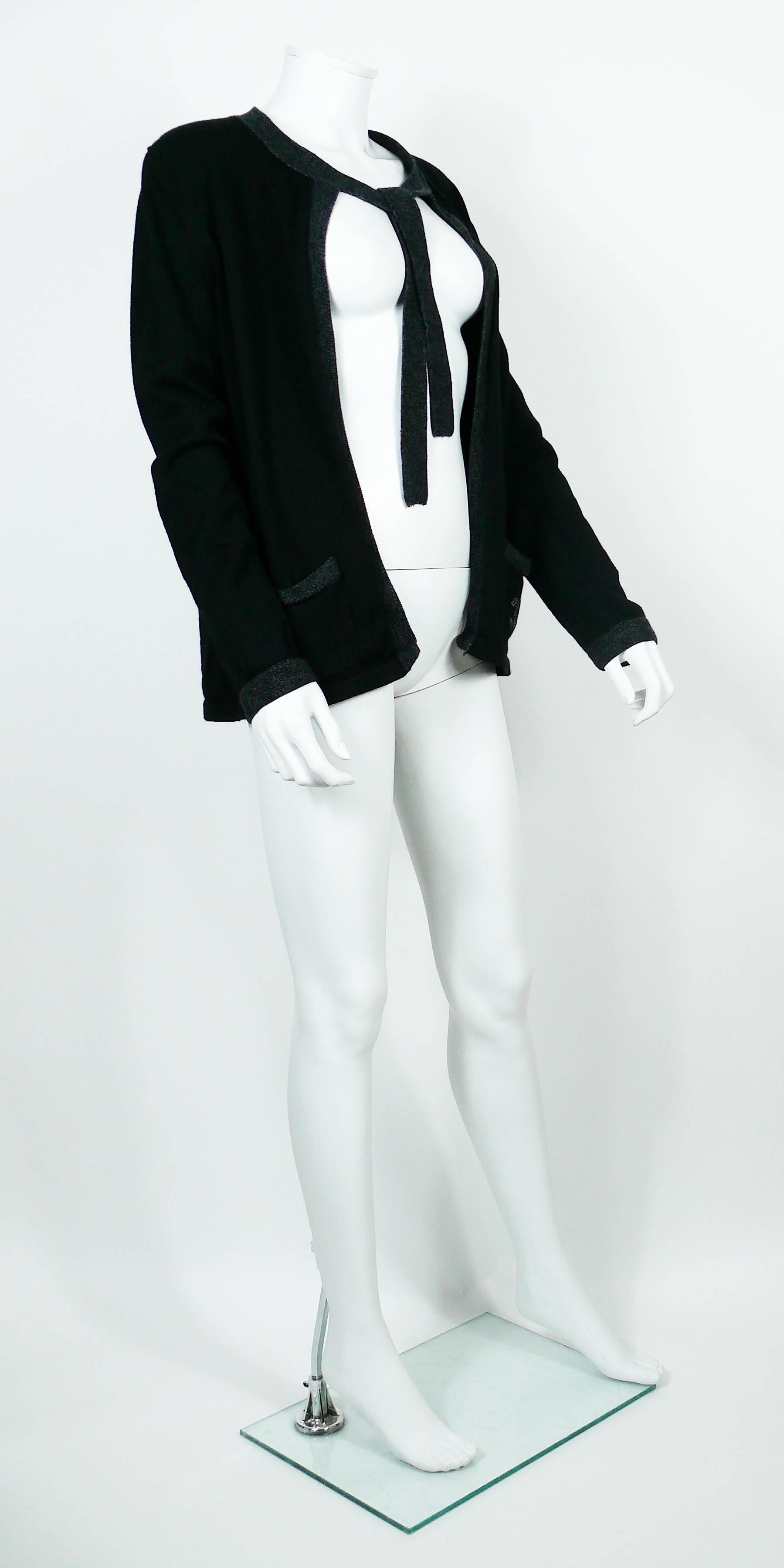 CHANEL Uniform black wool cardigan with grey trim and CC logo detail on left pocket.

Please note this item was original part of a CHANEL employee uniform.

Label reads CHANEL UNIFORM.
Made in China.

Size tag reads : XL.
Please refer to