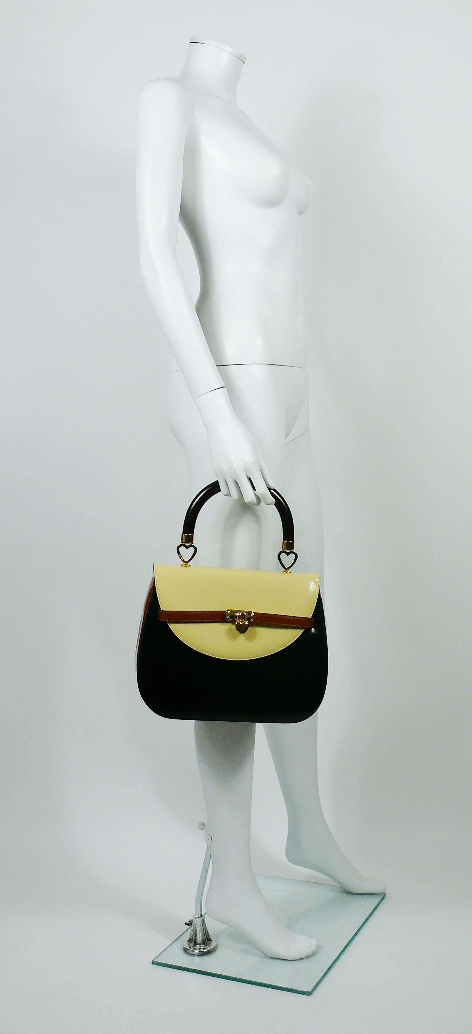 MOSCHINO vintage color block (black/brown/off-white) leather and wooden handle handbag.

Gold tone hardware.

Kelly style front closure.

One inside zippered pocket.

Redwall black monogram fabric lining.

