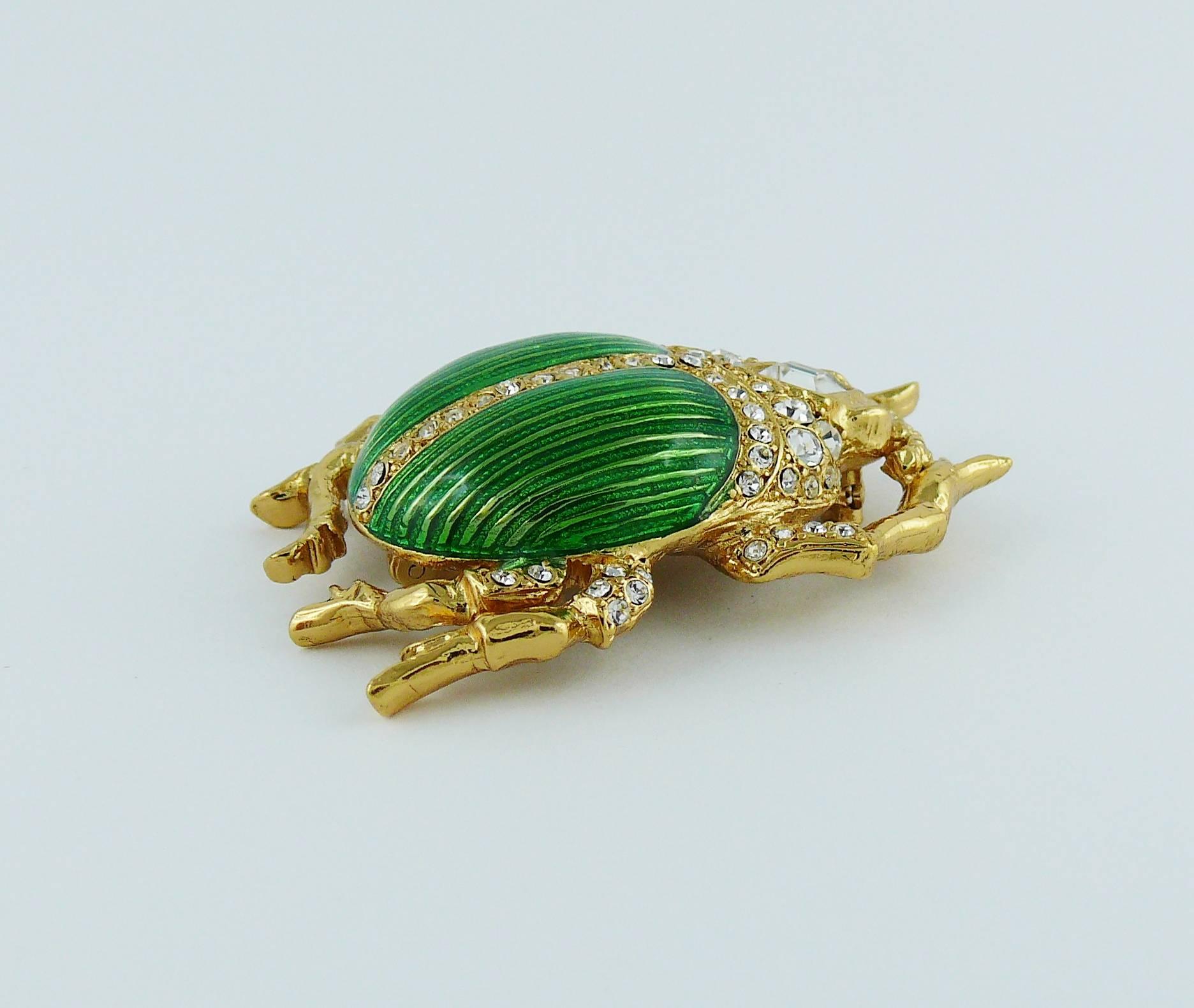 CHRISTIAN DIOR Boutique rare vintage jewelled scarab brooch.

Enameled gold tone metal, embellished with white rhinestones.

Marked CHRISTIAN DIOR Boutique.

Indicative measurements :  length approx. 4.2 cm (1.65 inches) / width approx. 3 cm (1.18
