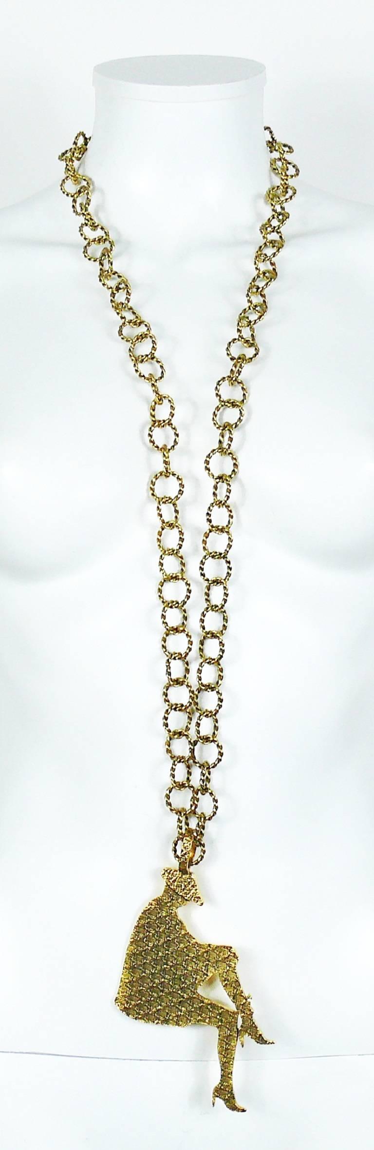 YVES SAINT LAURENT antiqued gold tone chain sautoir necklace featuring a massive textured sitting woman silhouette pendant inspired by MONSIEUR SAINT LAURENT fashion photos.

As seen on the runway at the Fall/Winter RTW 2010 Collection designed by