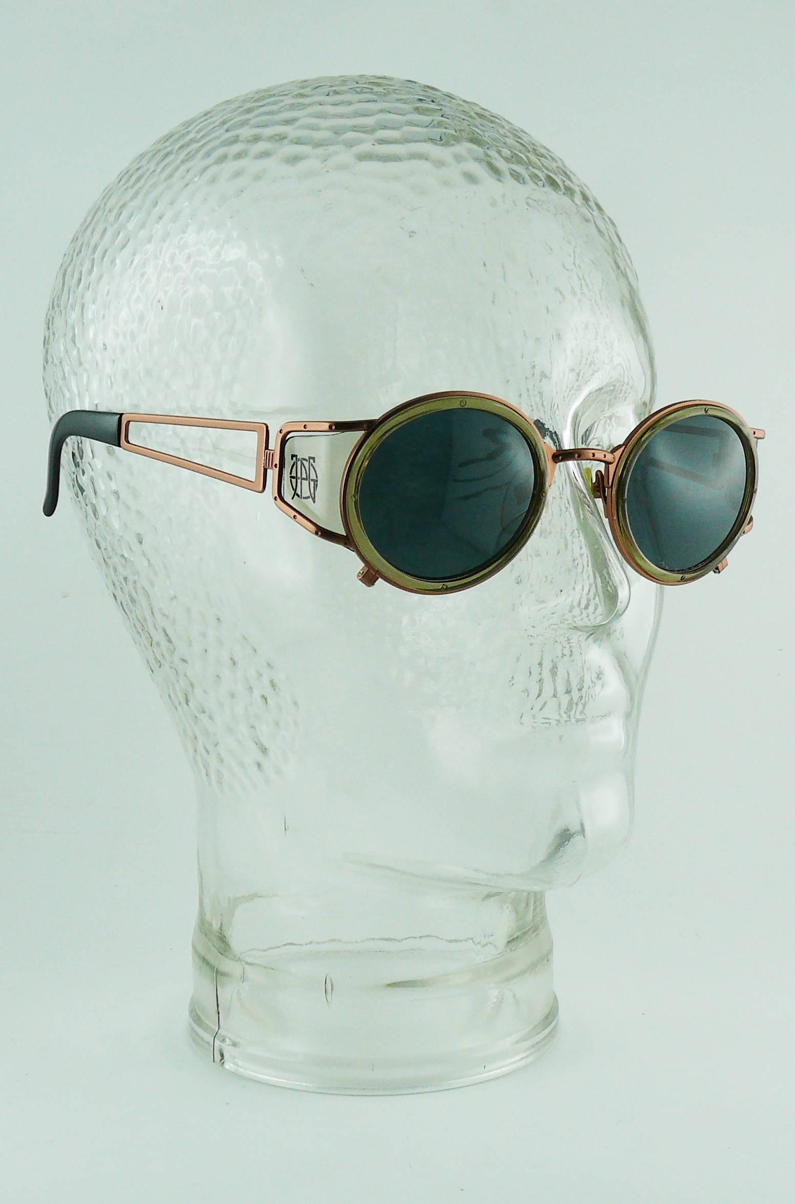 JEAN PAUL GAULTIER vintage steampunk sunglasses with side shields.

Copper toned frame featuring clear plastic side shields with JPG logo.
Tinted lenses.

Indicative measurements : max. width approx. 13.2 cm (5.20 inches) / width between lenses