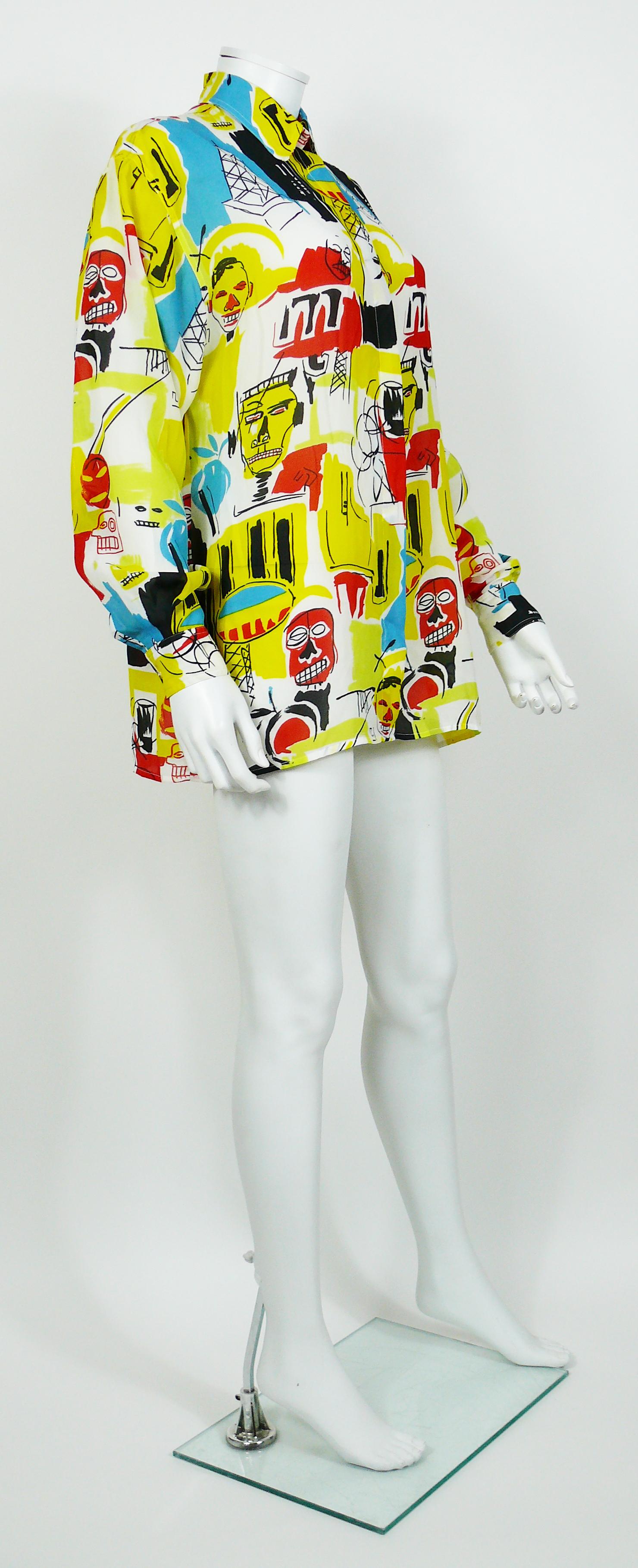 VERSACE JEANS COUTURE vintage multicoloured basquiat inspired print shirt.

This shirt features :
- Opulent multicolored design on a white background
- Long sleeves
- Classic collar
- Front buttoning
- Button cuffs
- Medusa silver toned