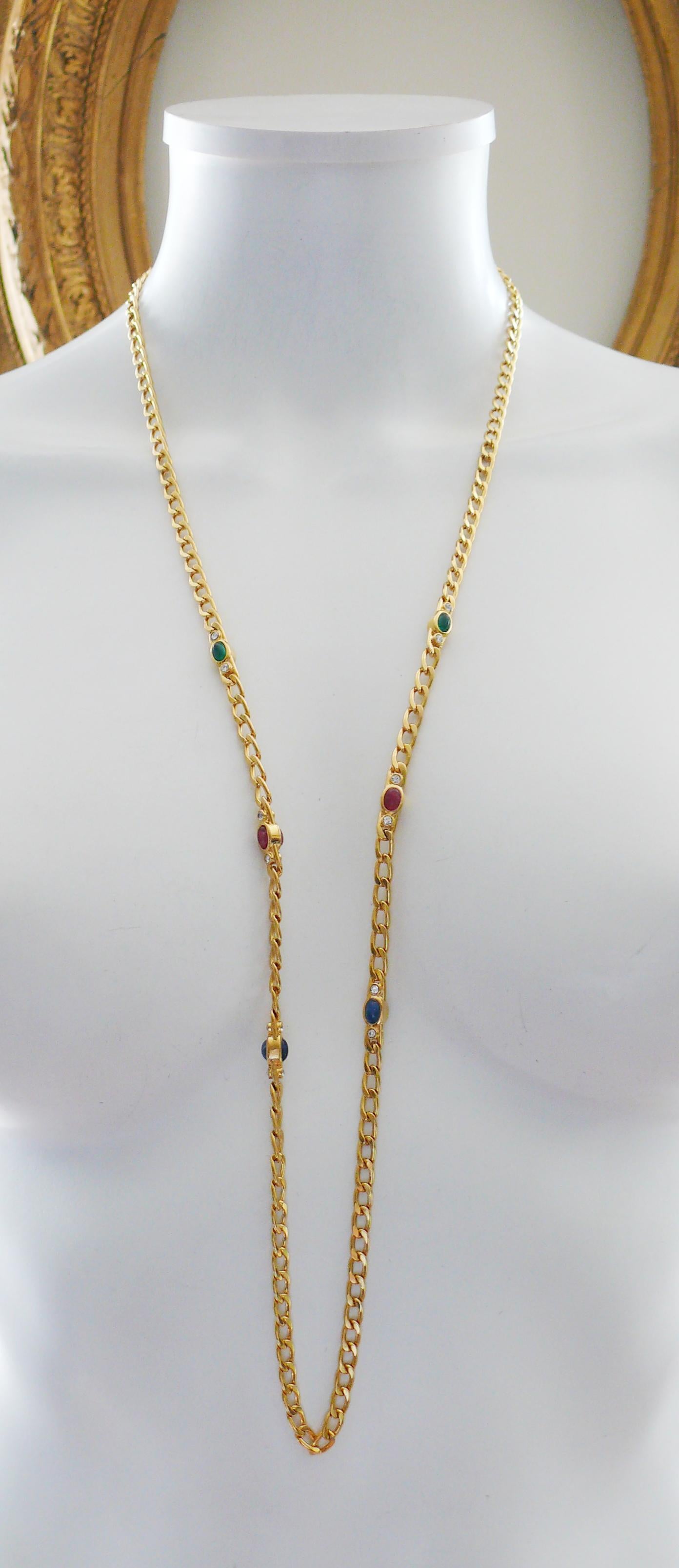 CHRISTIAN DIOR vintage gorgeous gold toned chain sautoir necklace featuring faux gem glass cabochons (sapphire, ruby, emerald) and clear crystals.

Secure clasp closure.

Embossed CHR. DIOR ©.

Indicative measurements : total length approx. 88 cm