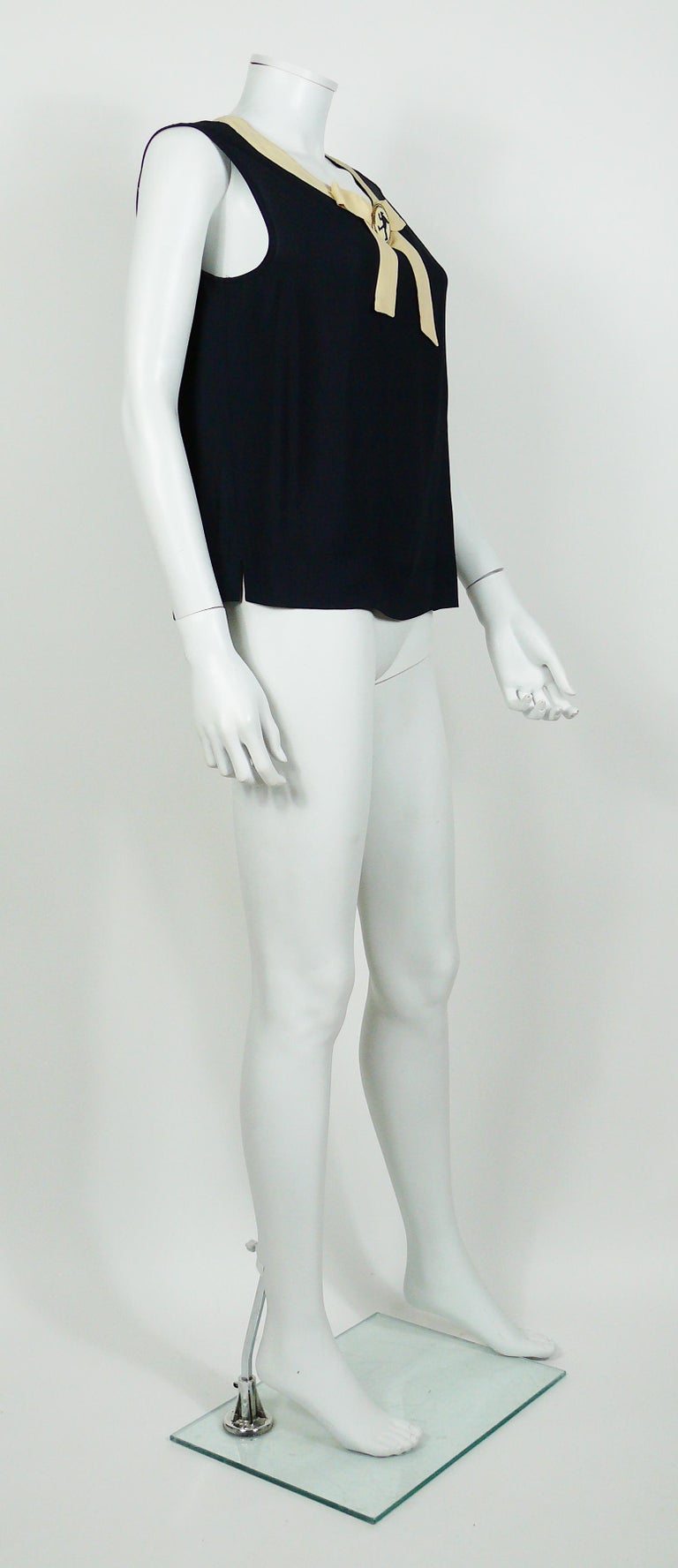 MOSCHINO navy blue sleeveless top featuring a black/white large cameo.

Label reads CHEAP AND CHIC by MOSCHINO
Made in Italy.

Size tag reads : I 48 / D 42 / F 42 / GB 14 / USA 12.
Please refer to masurements.

Composition tag reads : 75% Rayon /