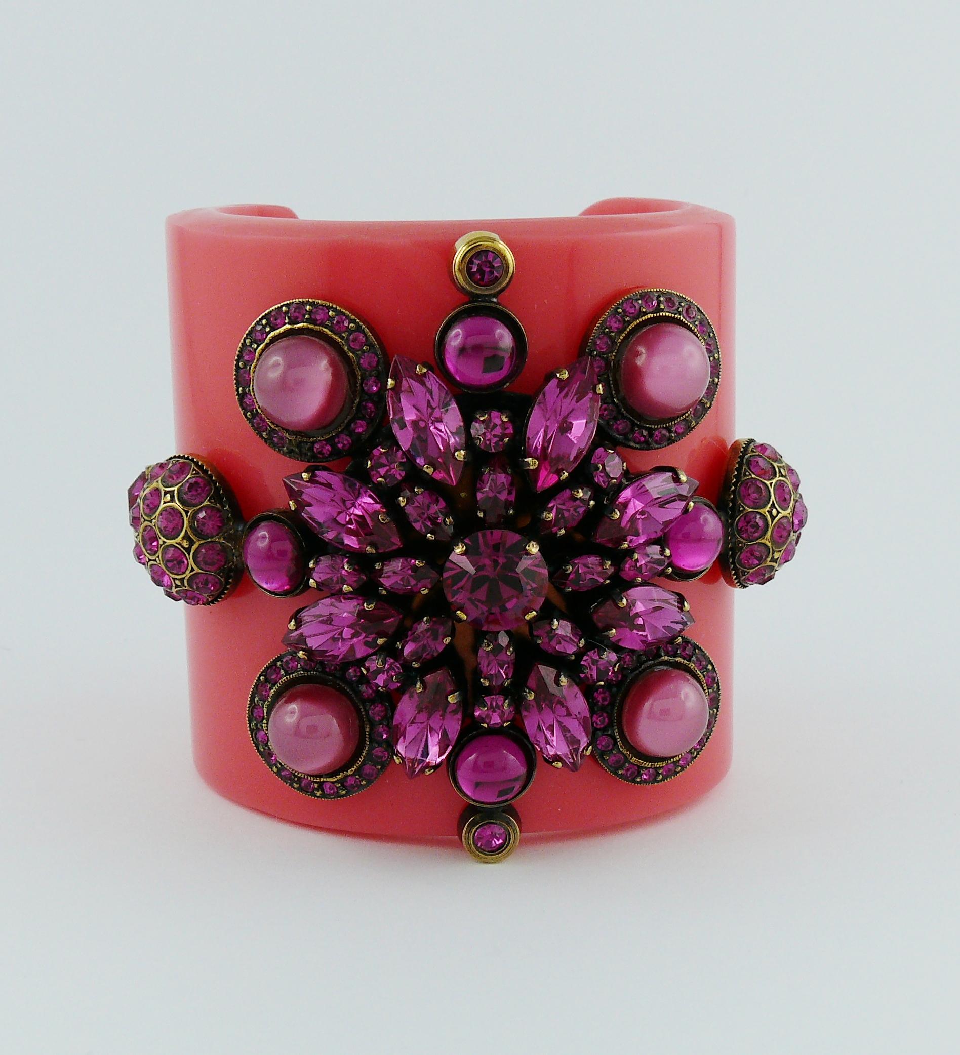 EMILIO PUCCI pink resin cuff bracelet embellished with fuchsia crystals and glass cabochons.

Spring/Summer 2012 Collection.

Signed EMILIO PUCCI 2012.
Made in Italy.

Indicative measurements : inner measurements approx. 5.4 cm (2.13 inches) x 4.6