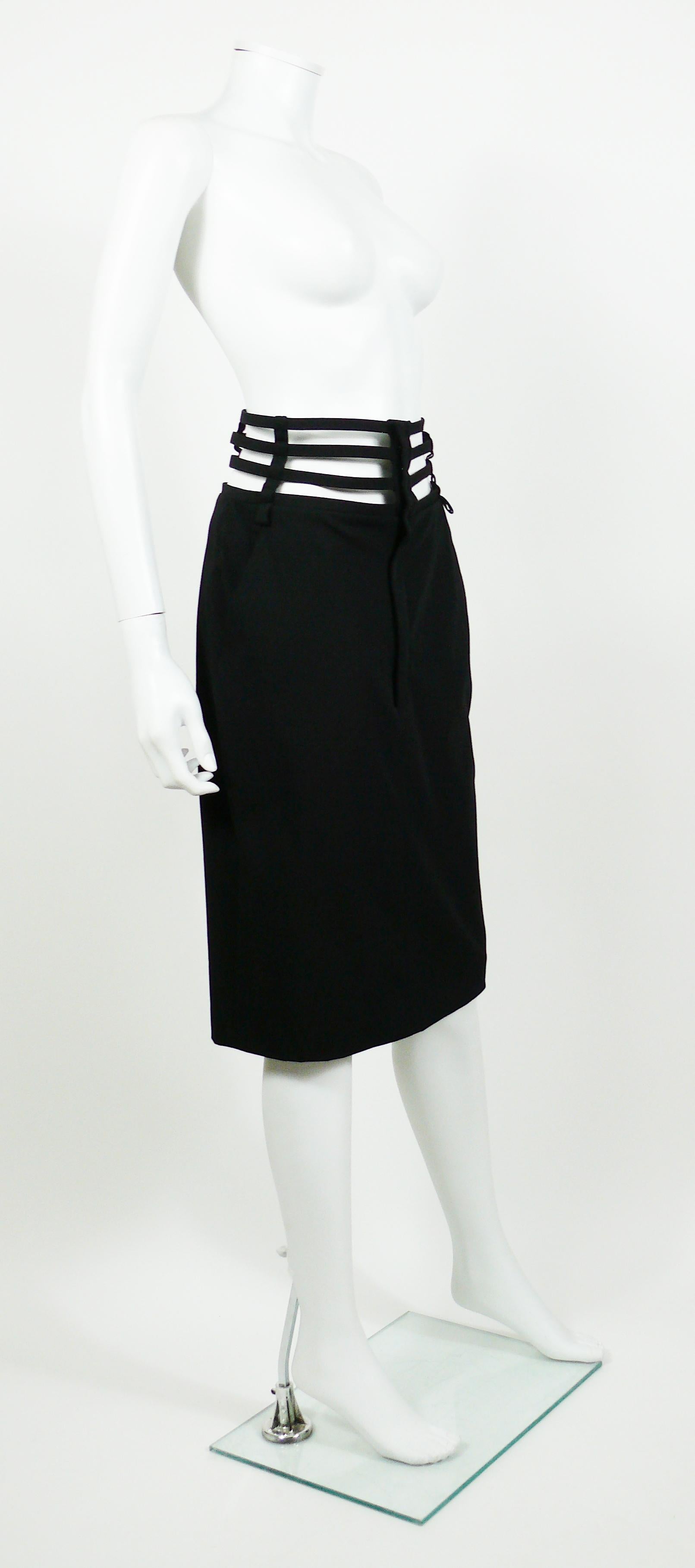 JEAN PAUL GAULTIER iconic black skirt with caging around the waist.

This skirt features :
- Knee length.
- Side pockets.
- Zip and snap closure at front.
- Belt loops.
- Stretchy fabric.
- Unlined.

Label reads JEAN PAUL GAULTIER Femme.
Made in