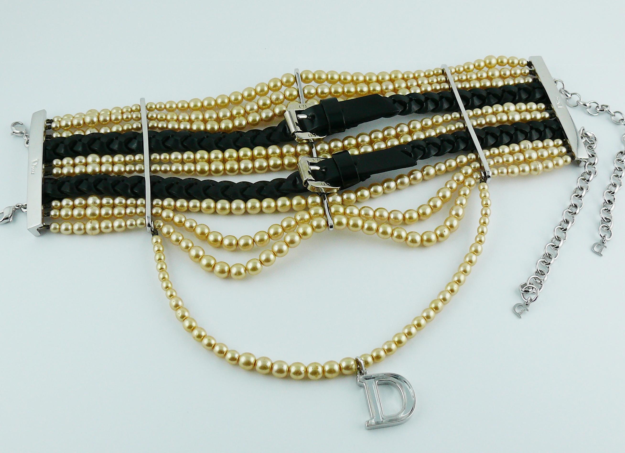 CHRISTIAN DIOR by JOHN GALLIANO Masai style choker necklace.

This necklace features : 
- Nine rows of graduated faux glass pearls.
- Two black braided leather straps with buckle in silver tone.
- Mirrored silver D charm at the centre.
- Double hook