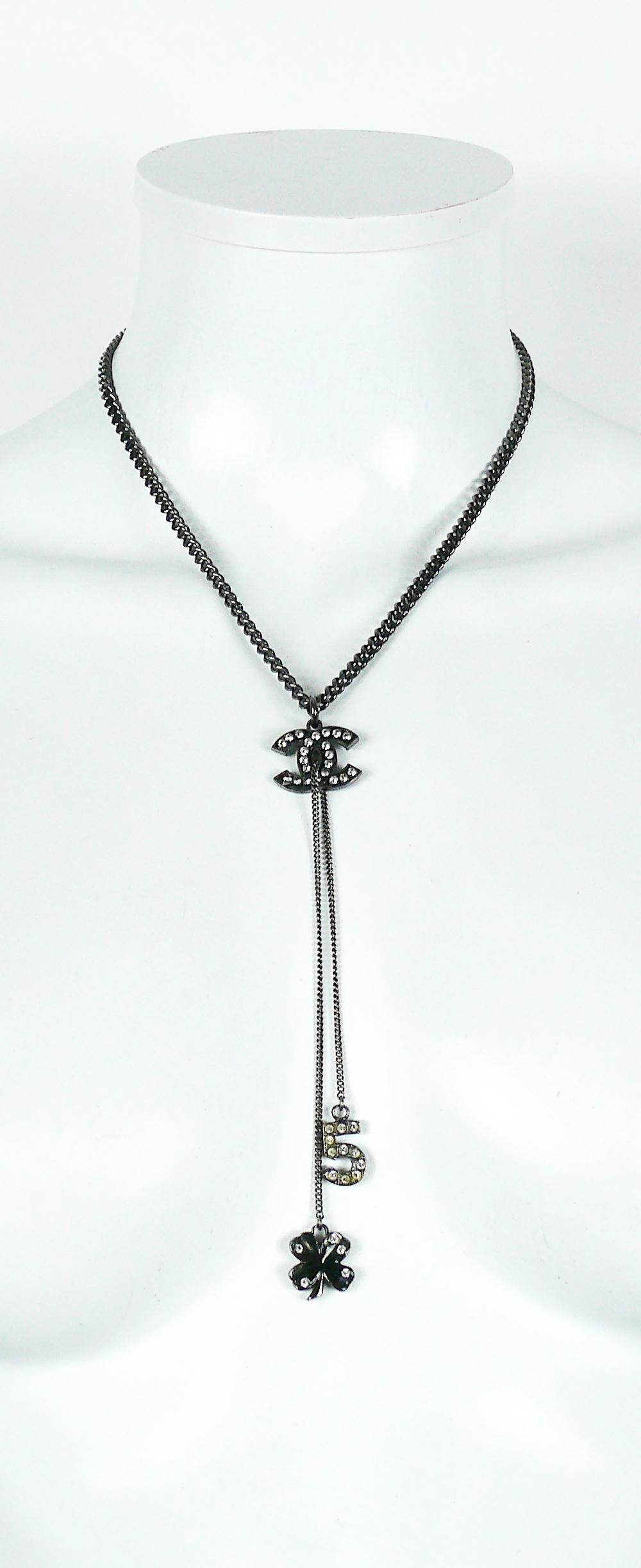 CHANEL ruthenium chain necklace featuring a CC pendant embellished with clear crystals, N°5 and clover charms.

T bar closure.

Fall 2003 Collection.

Embossed CHANEL 03 A Made in France.

Indicative measurements : chain length approx. 45 cm (17.72