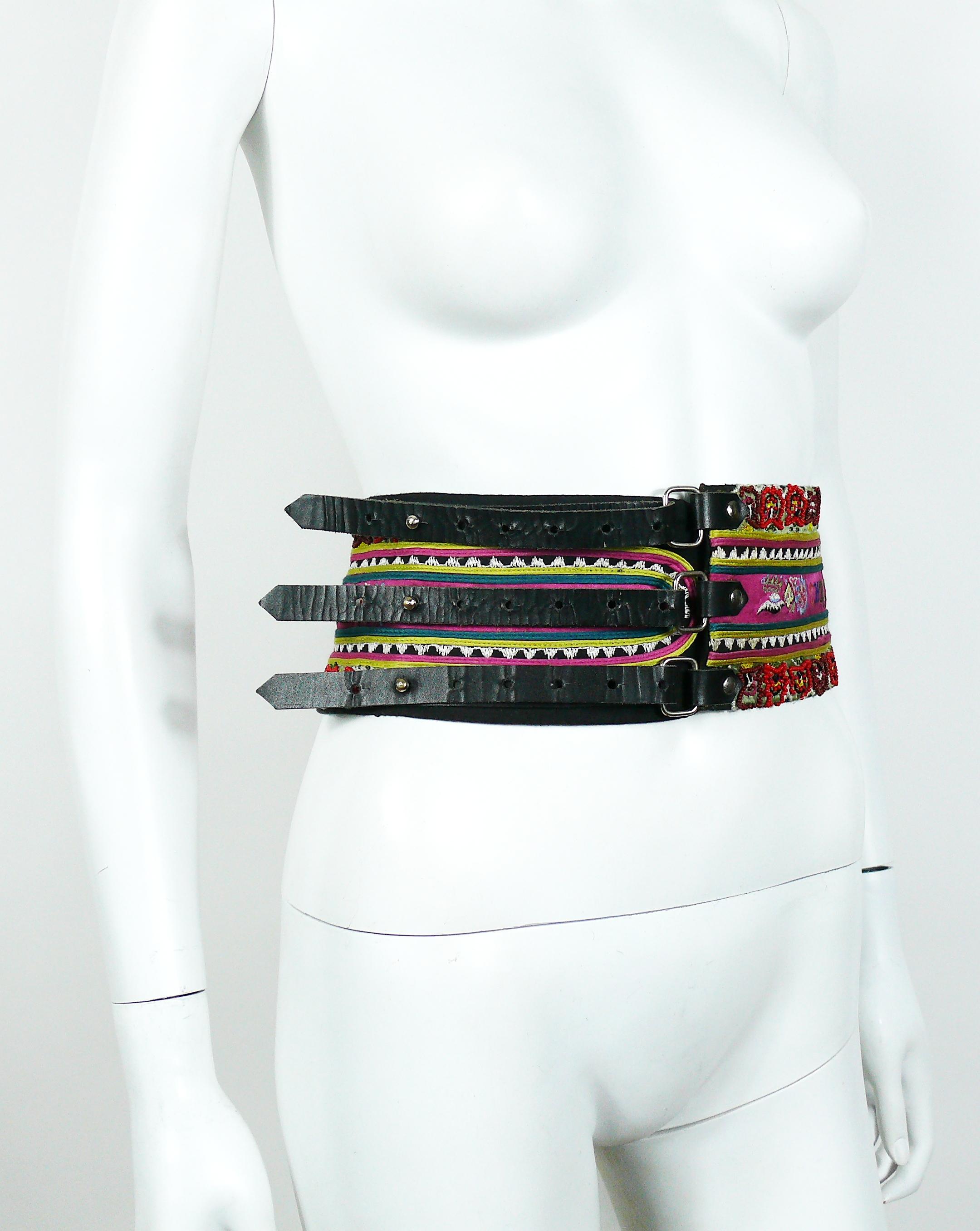 Christian Lacroix vintage ethnic inspired wide high waist textile belt featuring multicolored Indian embroideries and pearls.

This belt fastens with three black leather straps and rivet type snap/pop buttons.
Silver toned hardware.

Marked