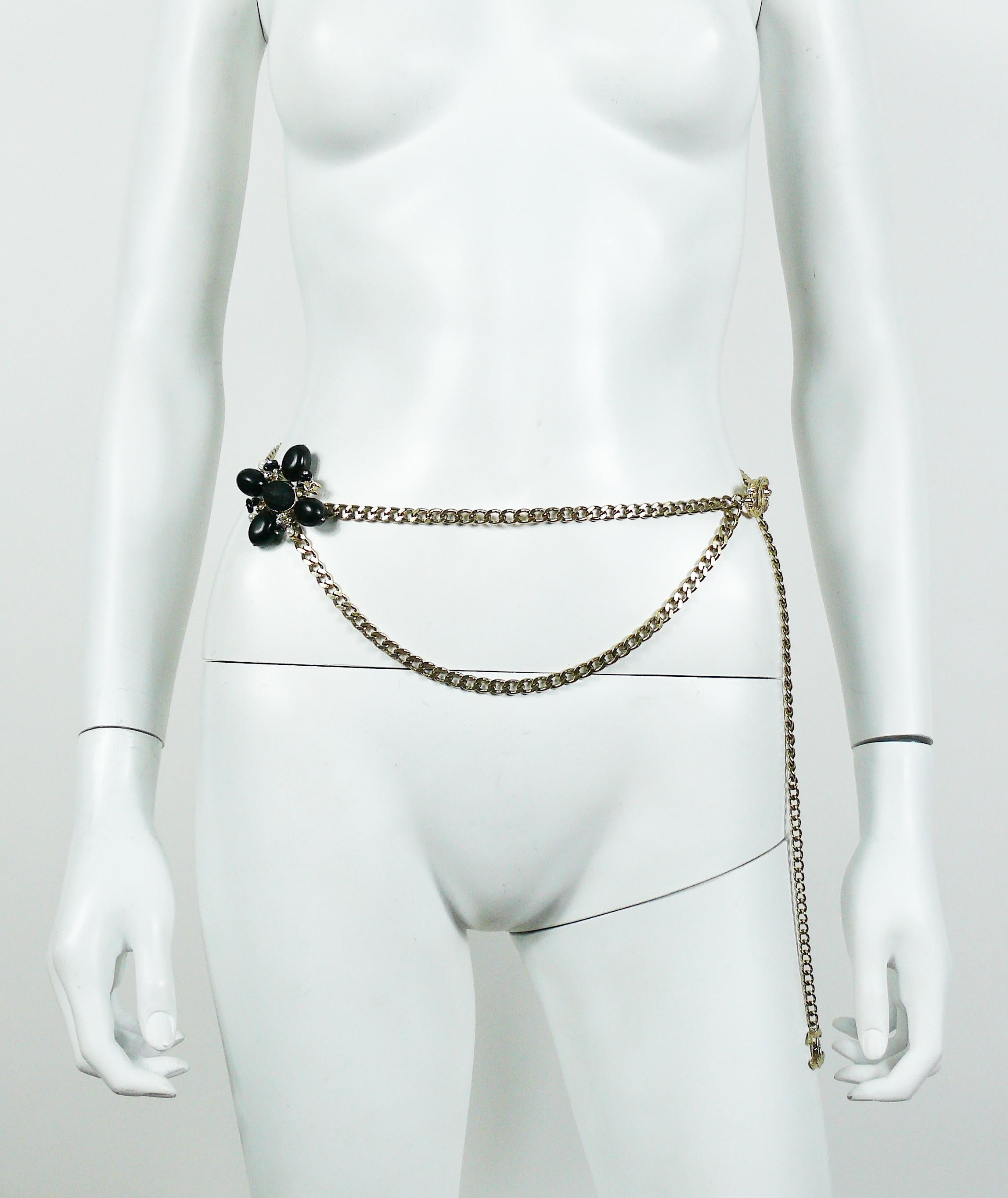 CHANEL light gold toned double chain belt adorned with a stylized black clover featuring large olive shaped resin cabochons, clear crystals, faux pearls, black/grey boucle tweed center and CC logo. CC logo drop at the end of the chain and CC logo