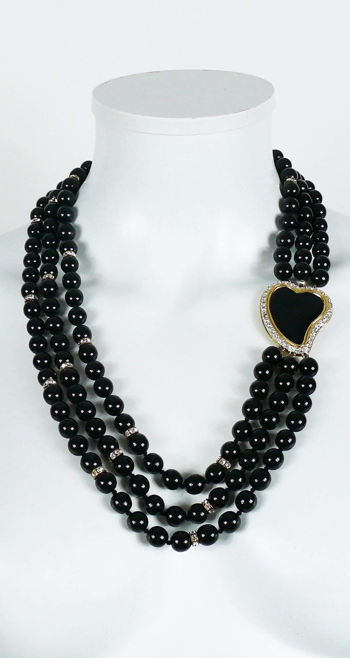 YVES SAINT LAURENT vintage three tiered black bead necklace embellished with clear crystal rondelles and a jewelled black enamel heart clasp.

Embossed YSL.

Indicative measurements : length approx. 61.5 cm (24.21 inches) / heart approx. 3.5 cm x 4