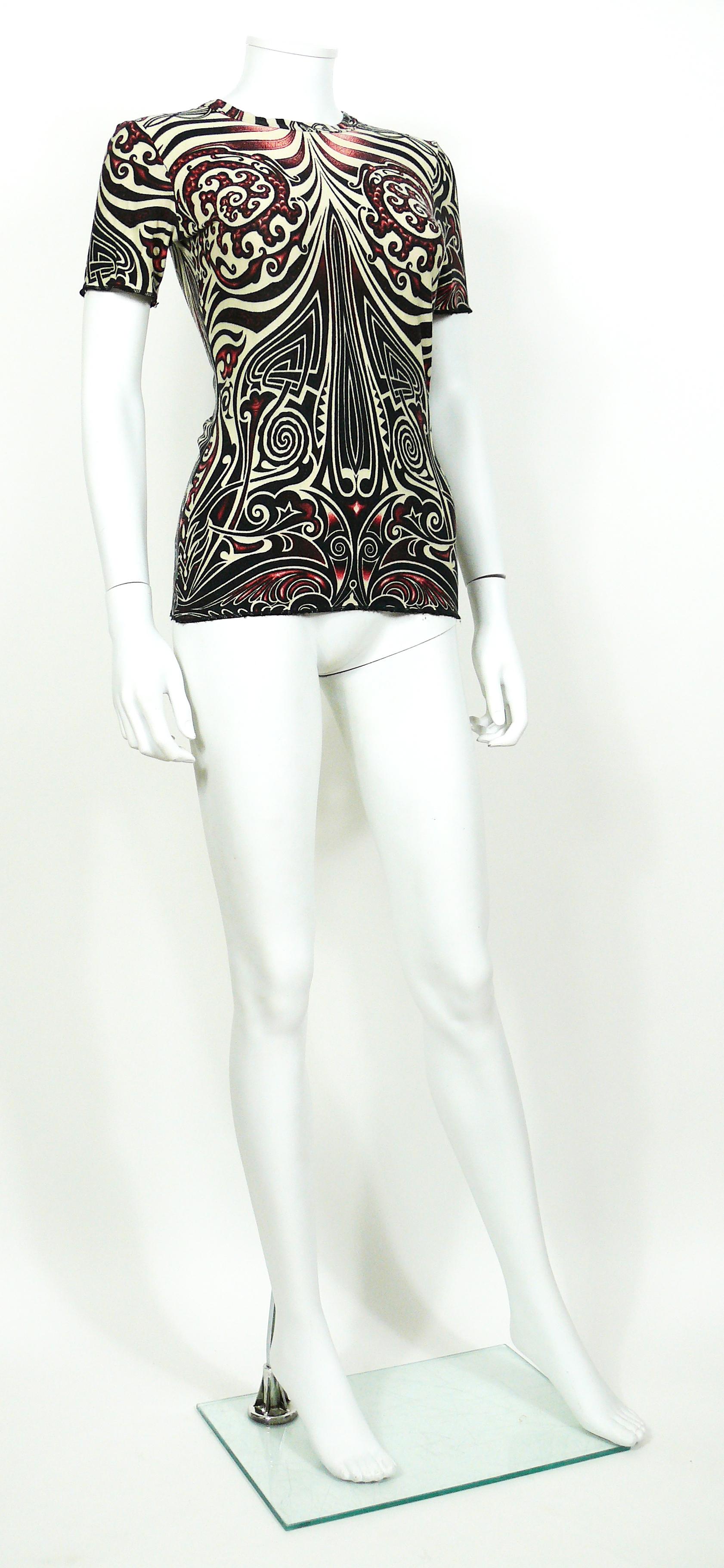 Jean Paul Gaultier vintage top featuring an opulent Aboriginal Maori tattoo print.

Stretchy material.

Label reads Gaultier Jeans.
Made in France.

Size tag reads : 38.

Indicative measurements taken laid flat and unstretched (double bust) :
