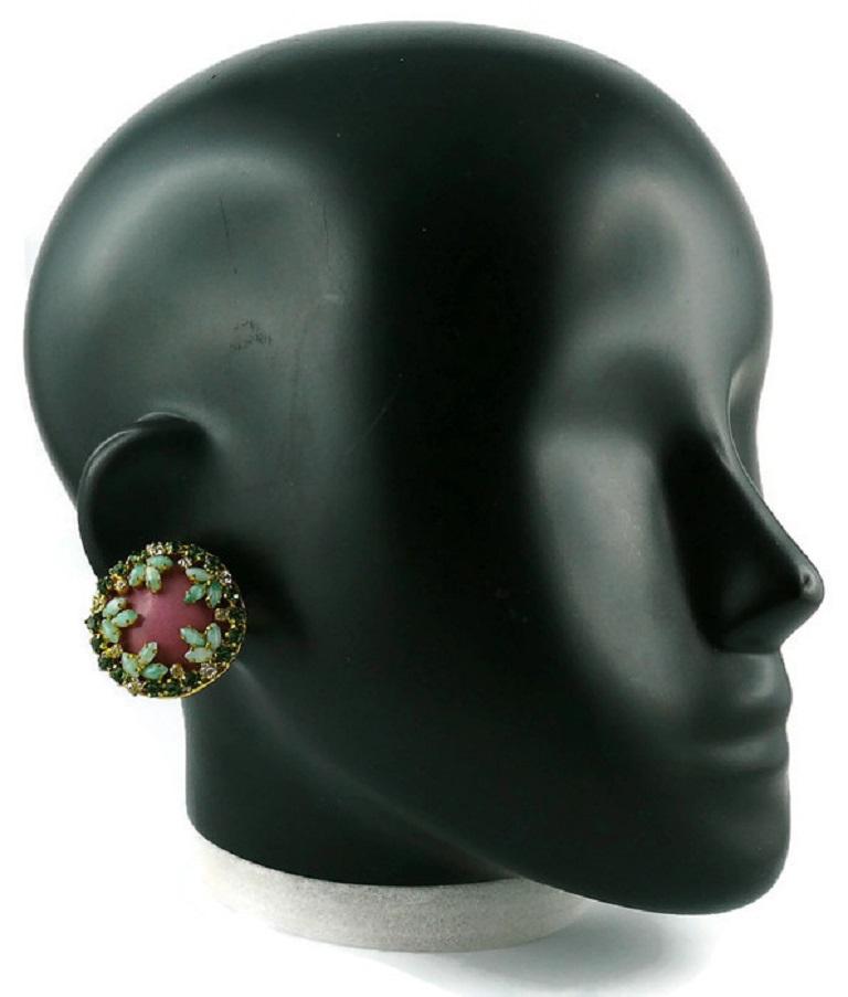 CHRISTIAN DIOR vintage 1960s gold toned clip-on earrings featuring a pink enamel center embellished with green shade crystals/glass cabochons and clear crystals.

Marked CHR. DIOR © Germany.
(Please note that one earring is dated 1967 and the other
