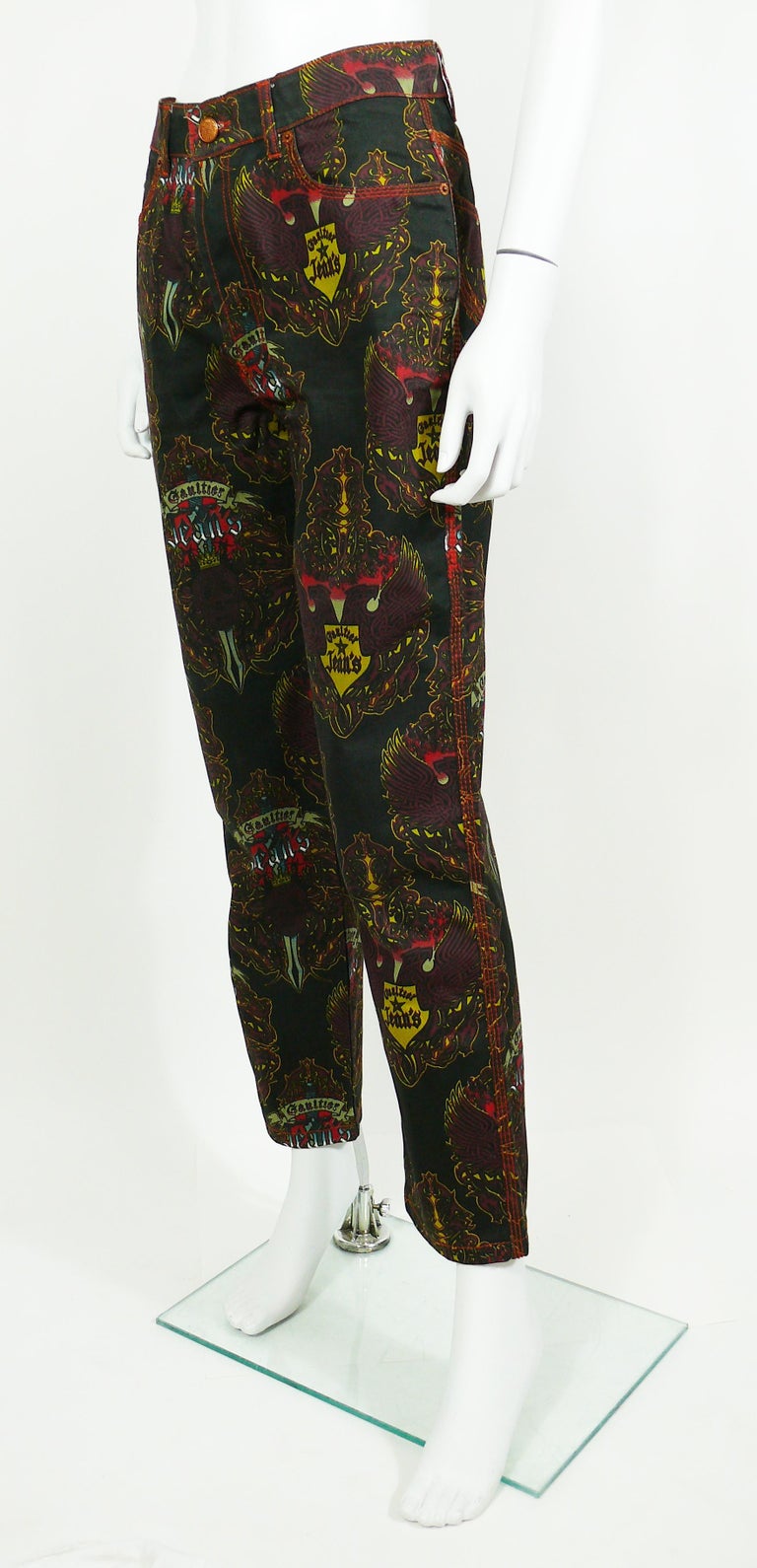 JEAN PAUL GAULTIER vintage black pants trousers featuring an opulent crowned skulls and eagles print design.

These trousers feature :
- Black background with multicolored designs throughout.
- Front buttoning.
- Copper toned signature buttons.
-