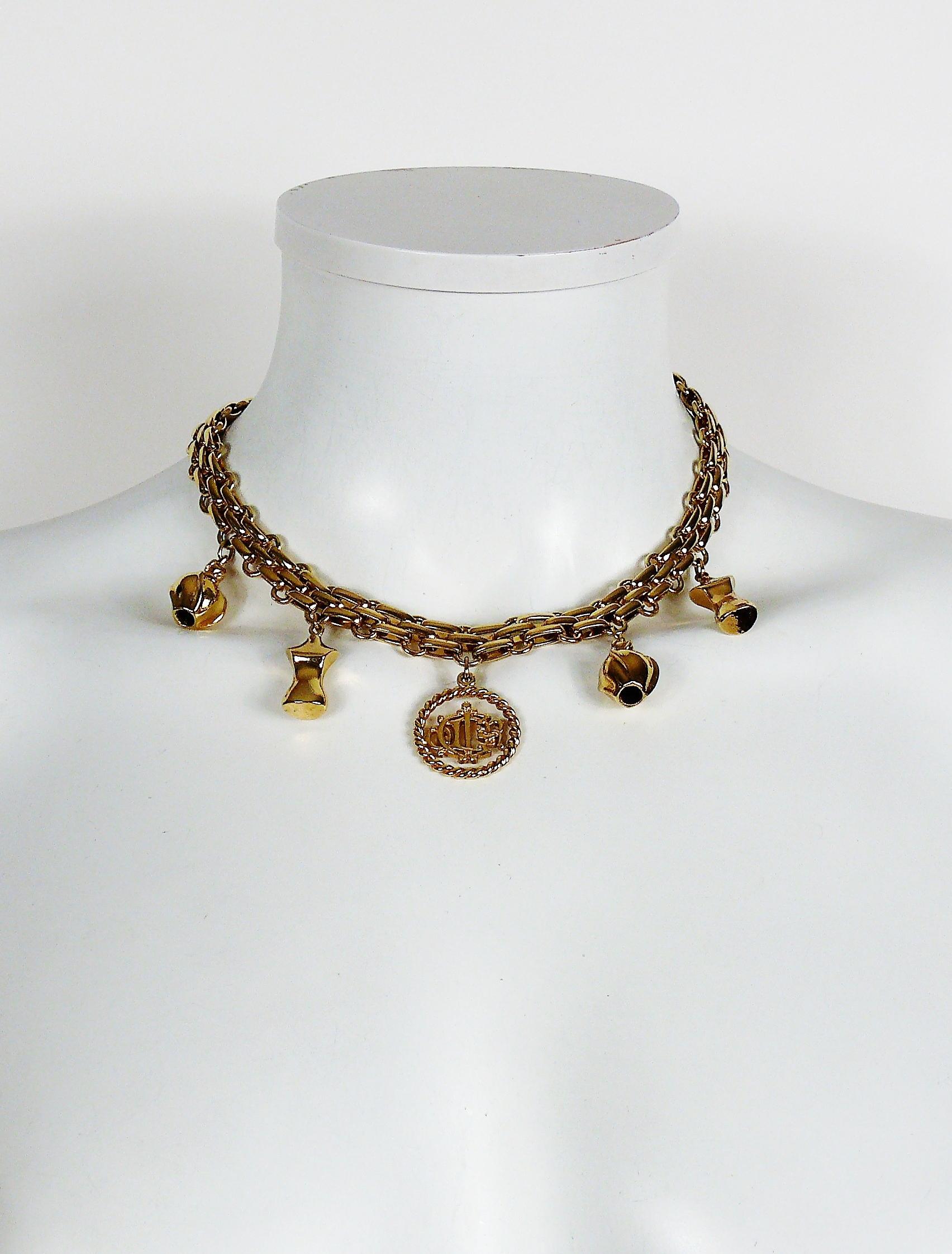 CHRISTIAN DIOR vintage gold toned necklace featuring various charms : perfume bottles, mannequin busts, CHRISTIAN DIOR insigna coin.

Embossed CHR. DIOR ©.
Germany.

Indicative measurements : length approx. 41 cm (16.14 inches).

NOTES
- This is a