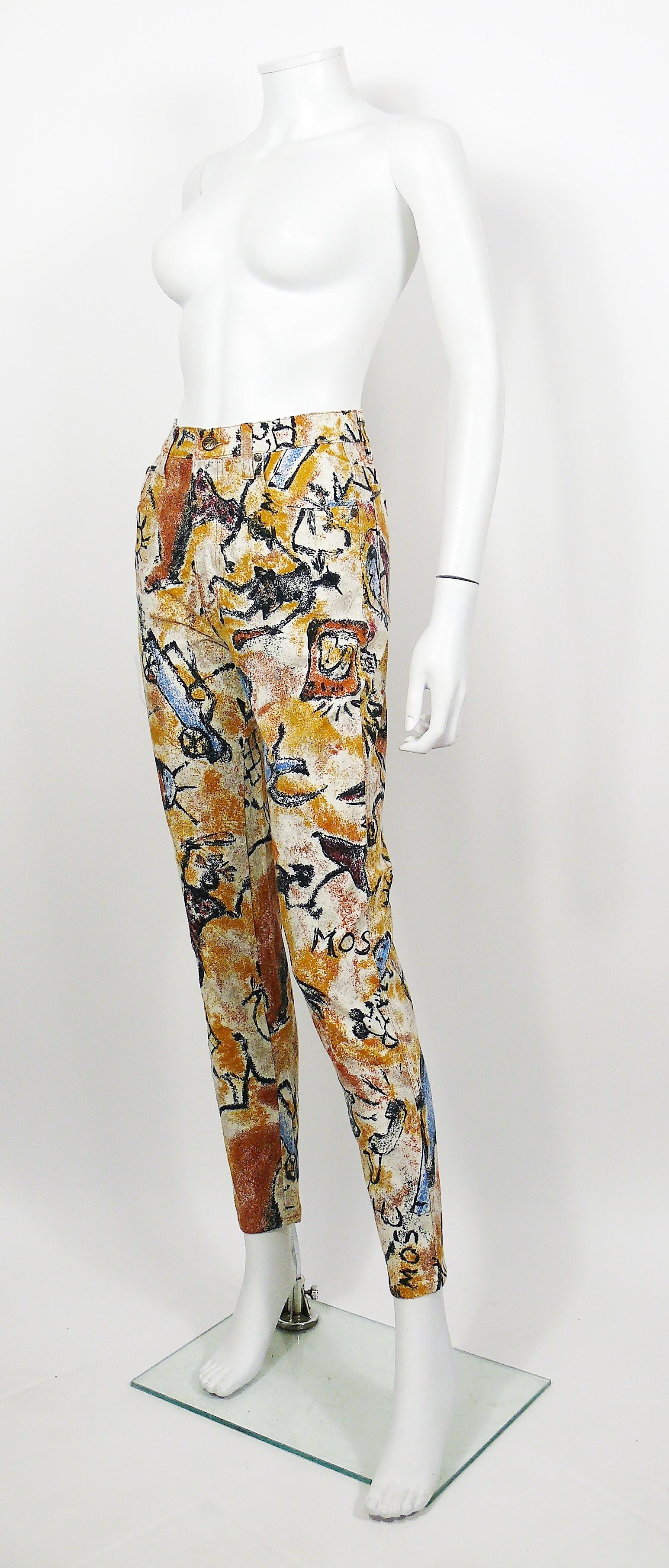 MOSCHINO vintage 1990s trousers featuring an opulent cave paintings print all over, MOSCHINO and peace sign.

These trousers feature :
- Cotton blend with stretch.
- Front buttoning and zip.
- Bronze toned peace sign button and rivets.
- Front and