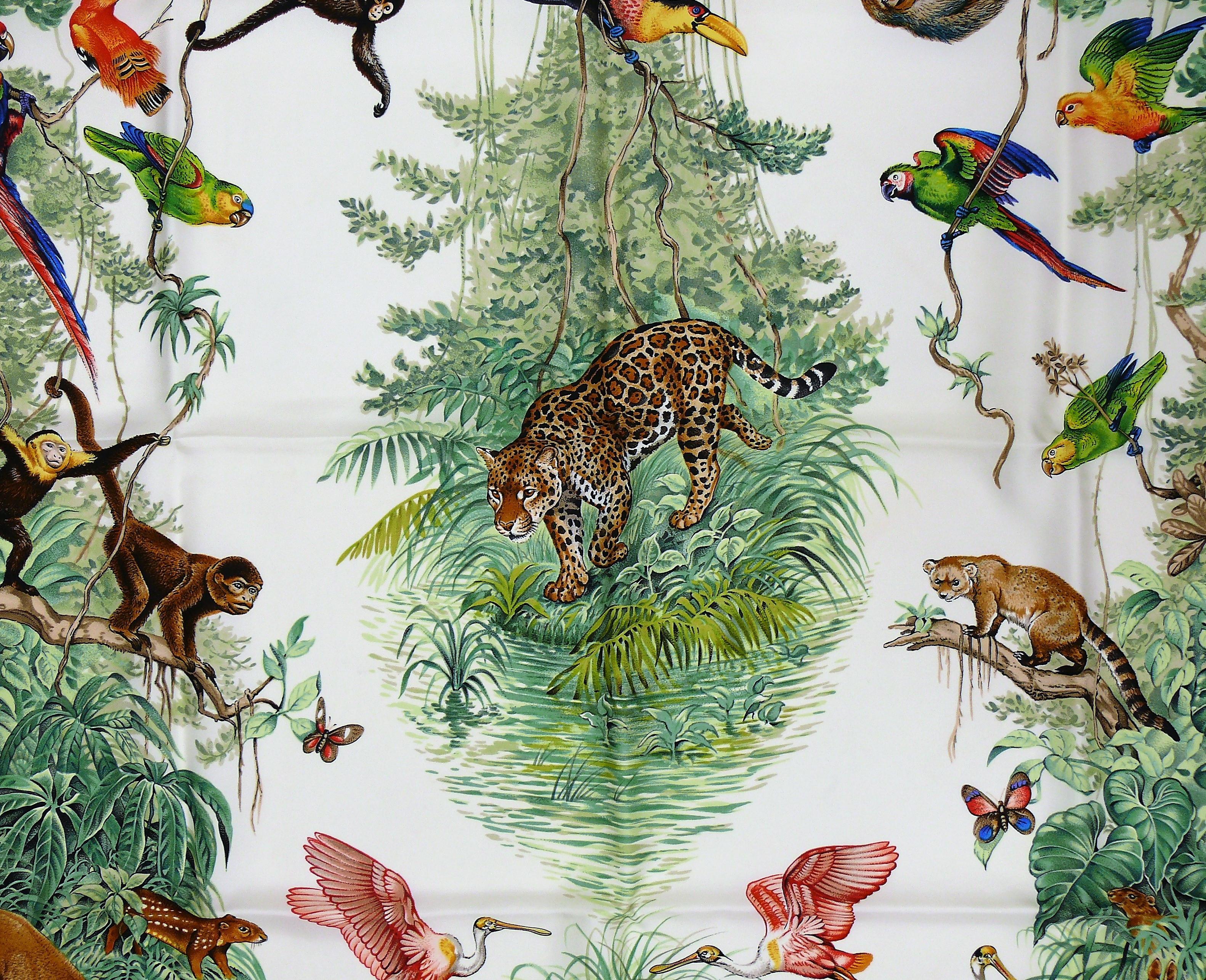 HERMES vintage silk carré scarf EQUATEUR featuring multicolored tropical wildlife on an off-white background.

First issued in 1984 and reissued in 1988/1989.

Designed by ROBERT DALLET.

This scarf features :
- Hand rolled borders.
- 100 % silk.
-