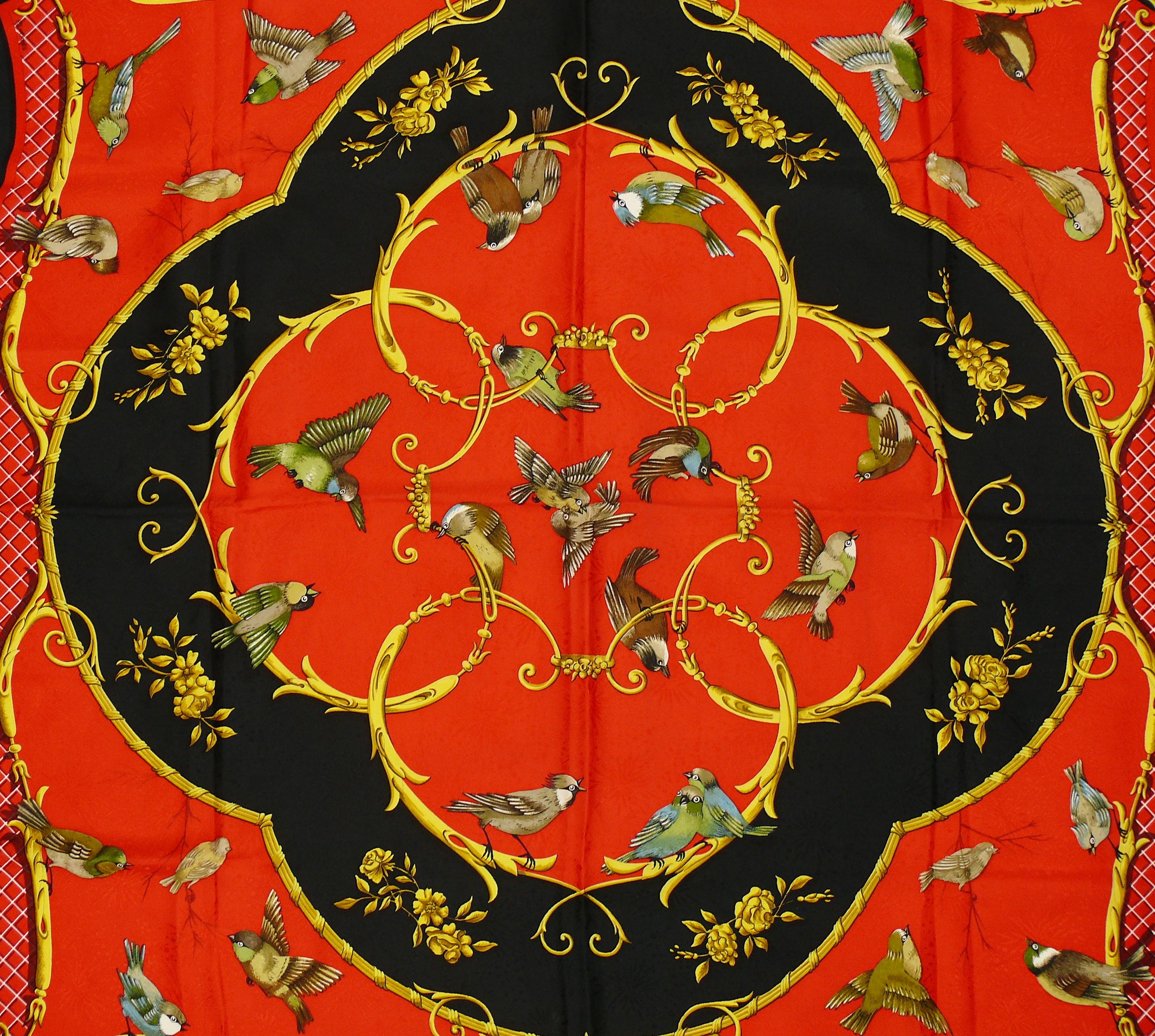 HERMES vintage rare jacquard silk carré scarf LA CLE DES CHAMPS featuring birds adorned with gold colored Baroque ornaments on a red and black background.

Designed by FRANCOISE FACONNET.

This scarf features :
- Hand rolled borders.
- Plump hems.
-