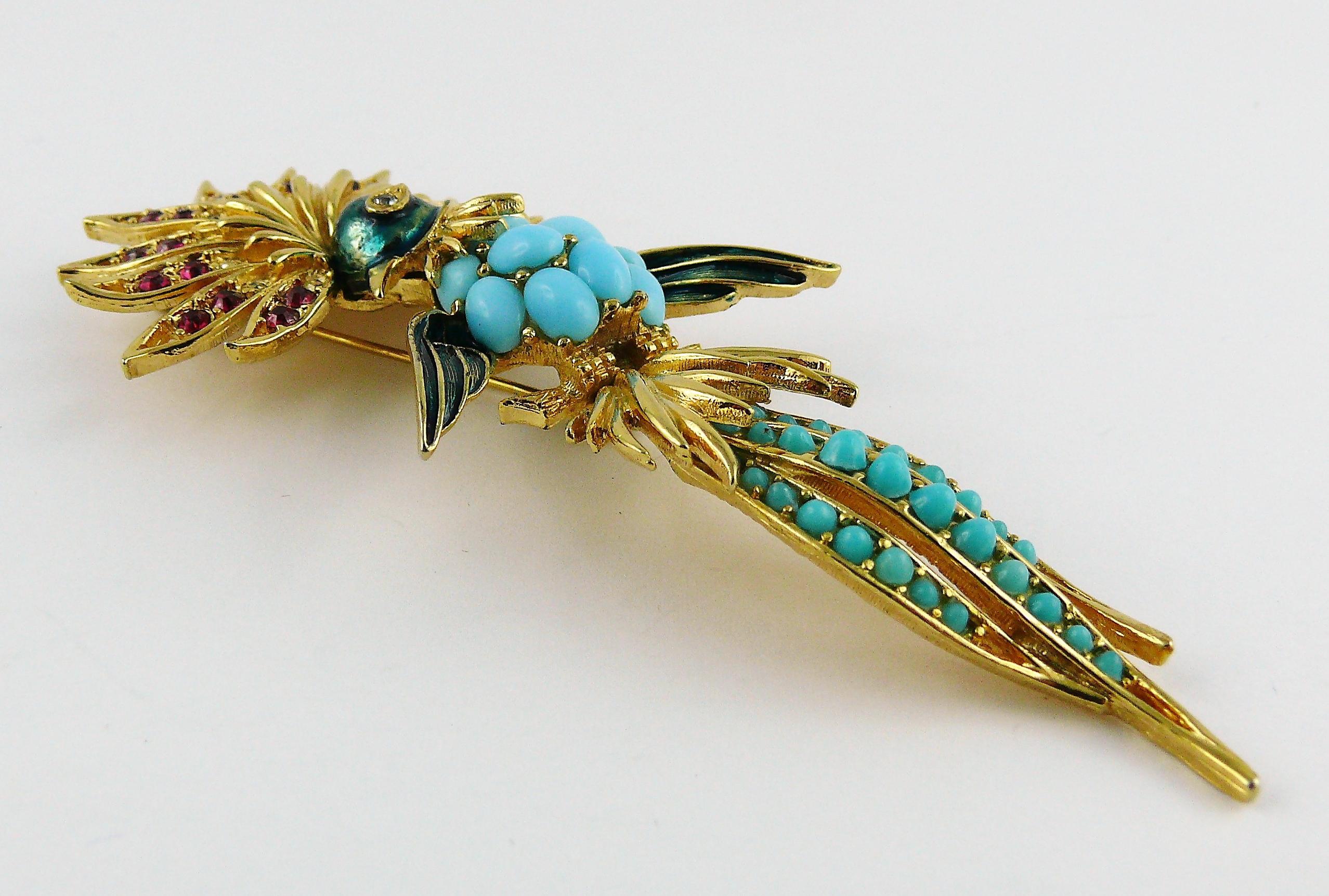 MARCEL BOUCHER gold toned bird of paradise brooch embellished with ruby rhinestones, clear crystals, faux turquoise cabochons and enamel.

Embossed BOUCHER.

Indicative measurements : max. height approx. 9.9 cm (3.90 inch) / max. width approx. 4.2