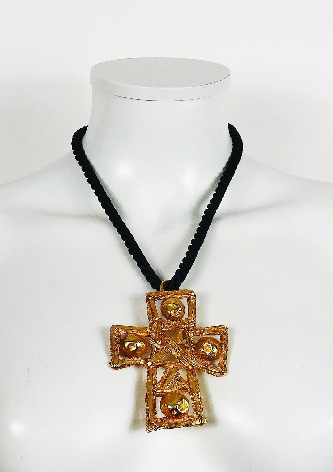 CHRISTIAN LACROIX vintage chunky textured gold toned openwork cross pendant with a black satin twisted rope cord.

The cross can be used as a brooch or pendant.

Hook clasp.

Marked CHRISTIAN LACROIX CL Made in France.
Embossed CL monogram on the