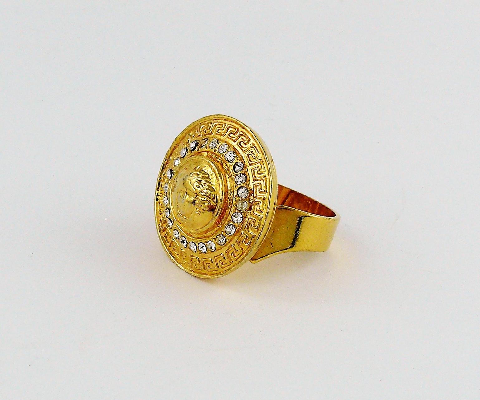 GIANNI VERSACE vintage gold toned MEDUSA ring embellished with clear crystals.

Adjustable size.

Embossed GIANNI VERSACE Made in Italy.

Indicative measurements : diameter approx. 2.2 cm (0.87 inch).

JEWELRY CONDITION CHART
- New or never worn :