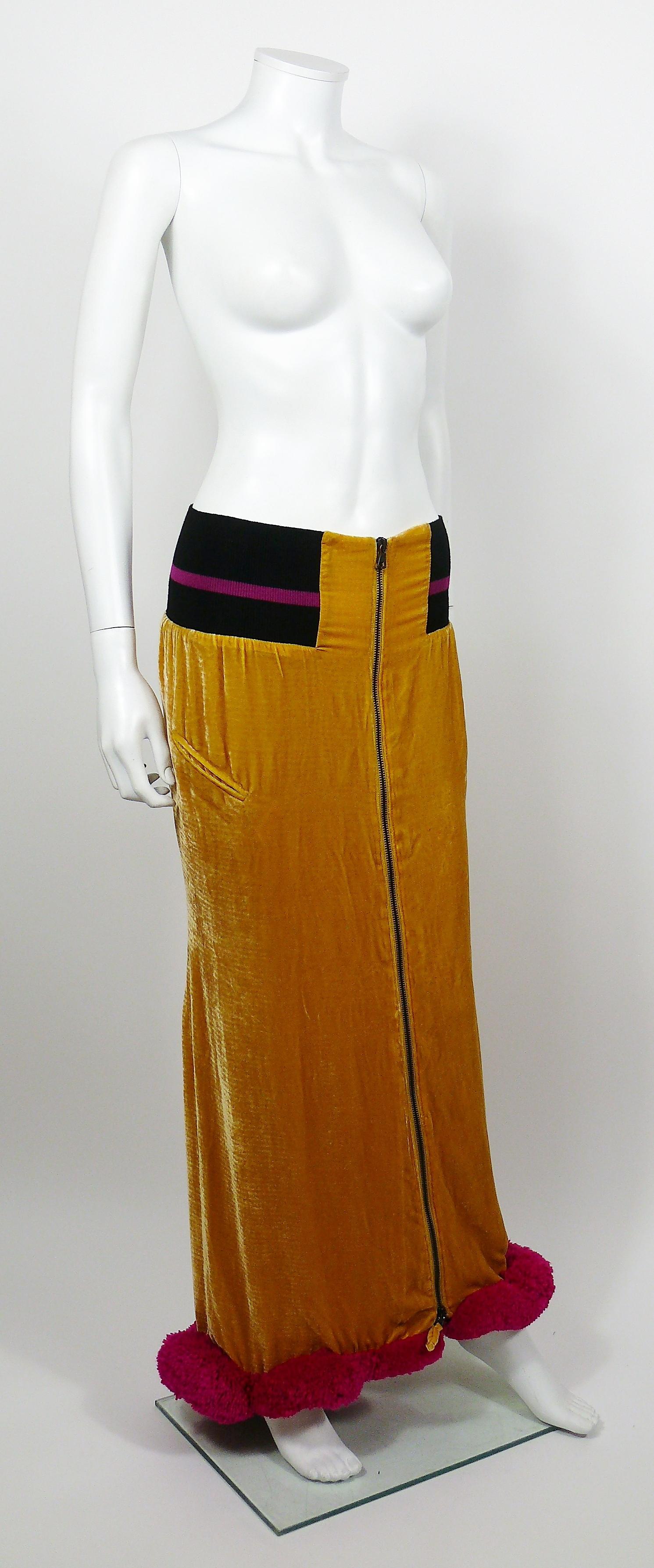 JEAN PAUL GAULTIER yellow maxi skirt featuring an extravagant cut out back, black striped knitted details, large fuchsia wool pudding trim, two faux pockets, zippered front and pink lining.

Label reads JEAN PAUL GAULTIER Femme.
Made in Italy.

Size