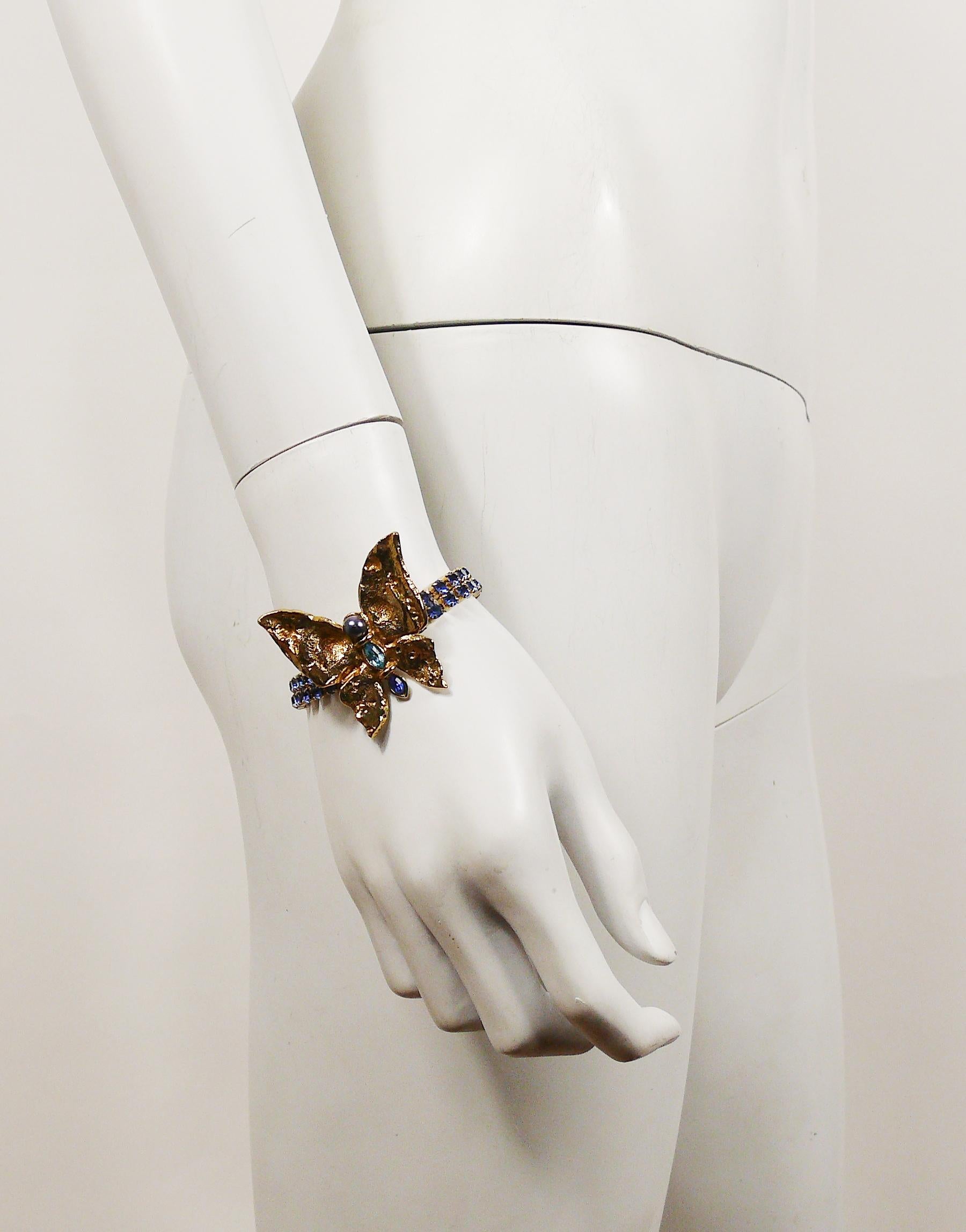 YVES SAINT LAURENT vintage textured gold toned butterfly bracelet embellished with blue faux pearl, sapphire and aqua rhinestones.

Embossed YSL Made in France.

Indicative measurements : length approx. 17.3 cm (6.81 inches) / butterfly max. height