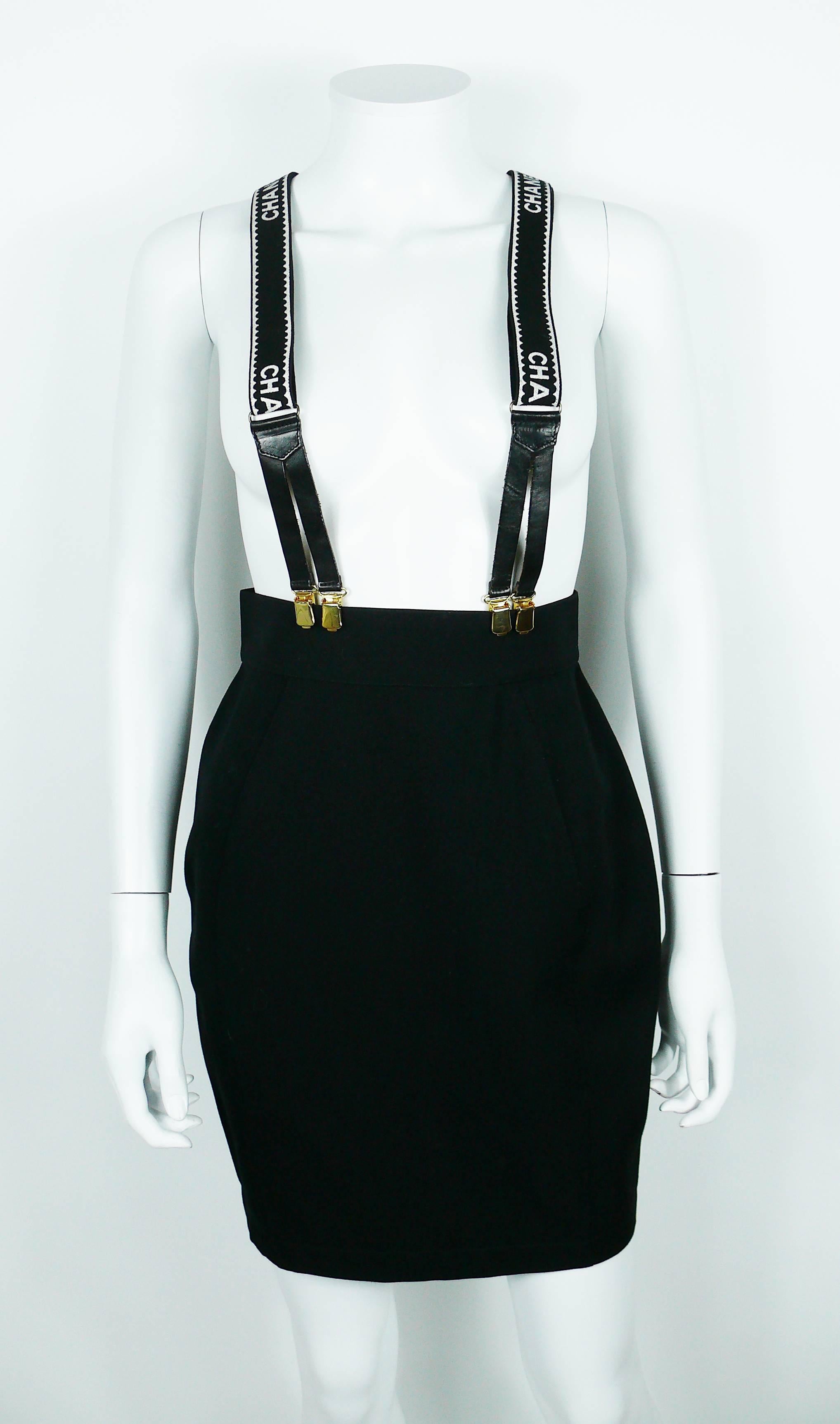 Chanel vintage iconic rare suspenders in black version with white printed lettering, gold toned hardware and leather trim.

CC logo printed on the leather.
Label "Fabriqué en France" (Made in France) on the reverse.

These iconic