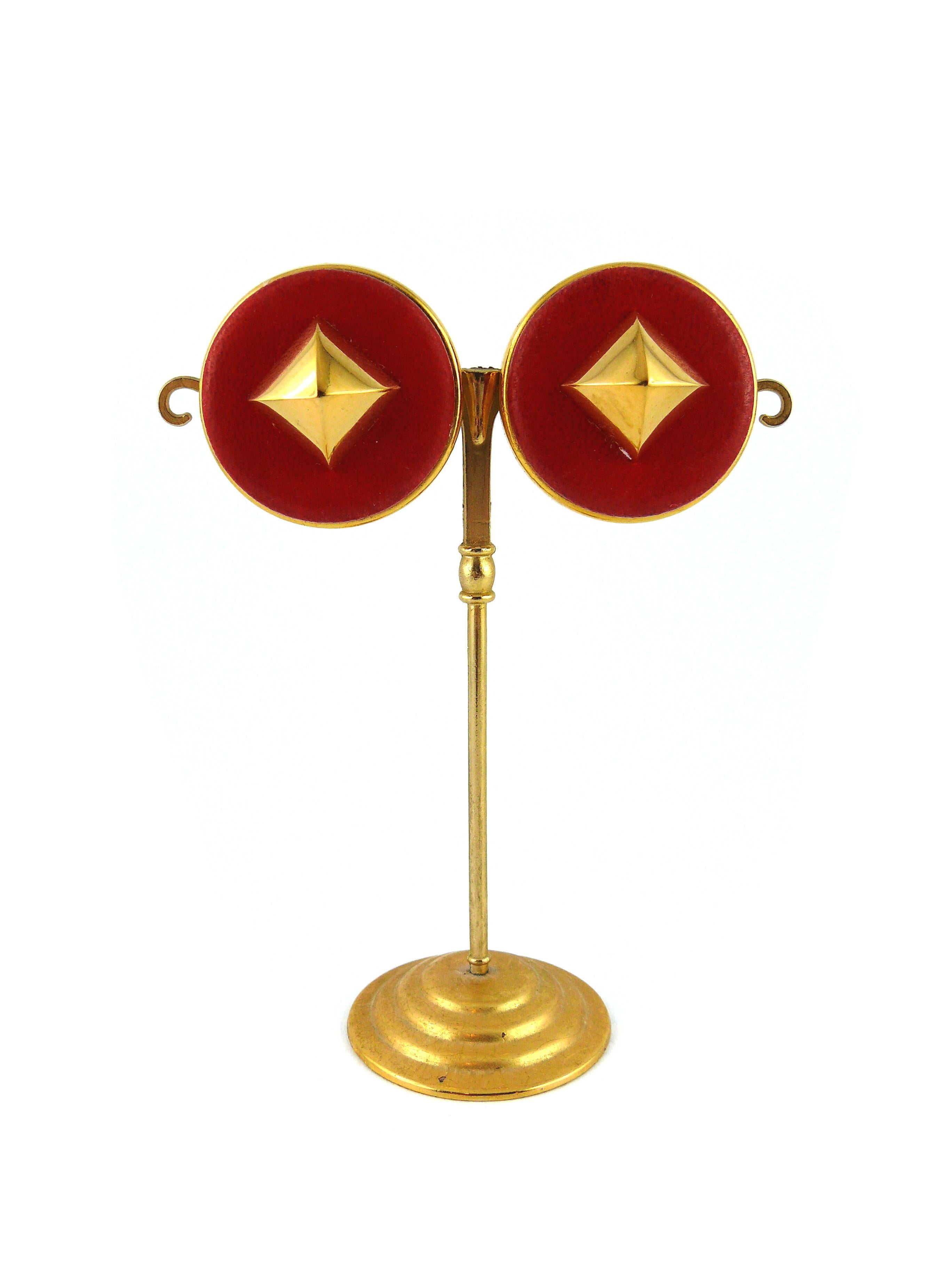 HERMES classic vintage Medor stud clip-on earrings.

Strawberry color lambskin leather embellished with gold tone pyramid shaped studs.

Marked Hermes Paris.

Note
As a buyer, you are fully responsible for customs duties, other local taxes