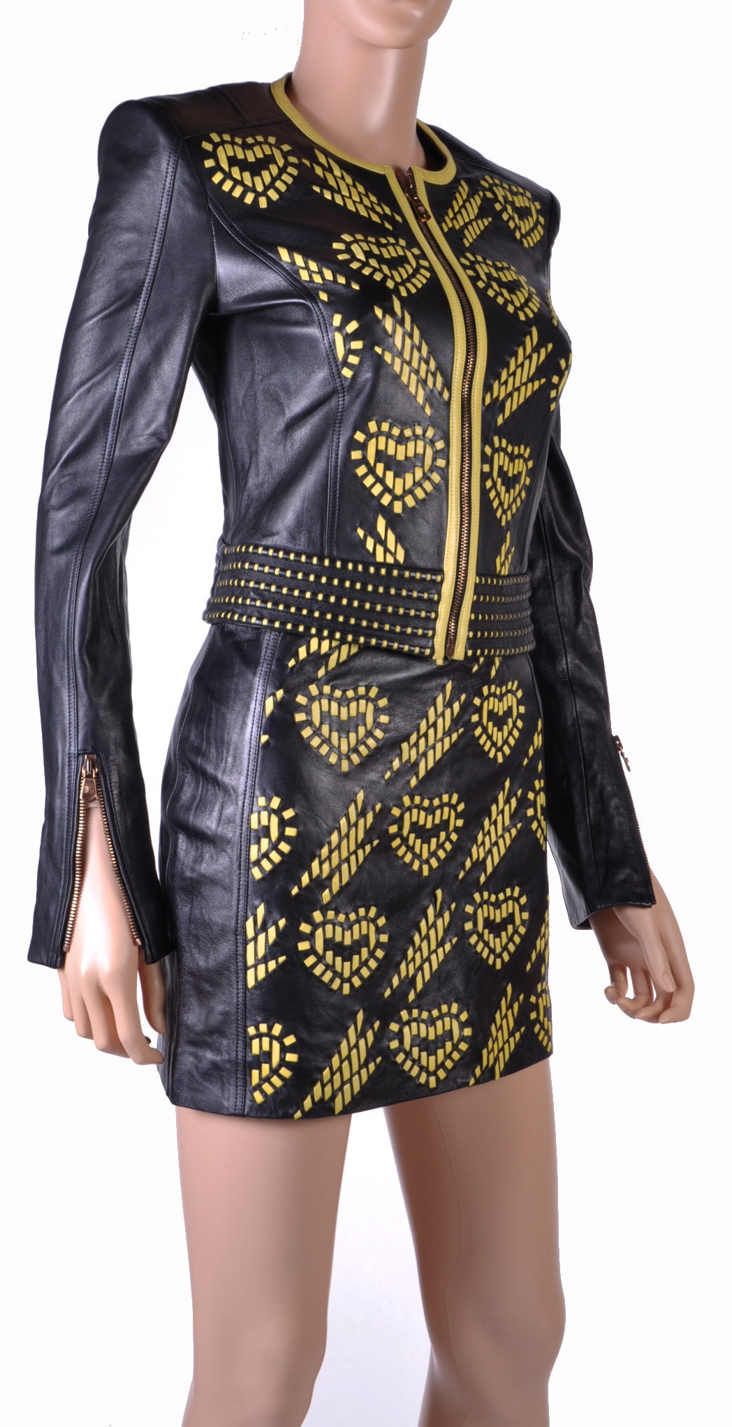 NEW VERSACE  SUIT

This fitted, black leather jacket is long sleeved 

and features round neck, laser cut applique and zip option at cuffs.

Front zip closure.

100% leather

Fully lined 

The skirt is 14