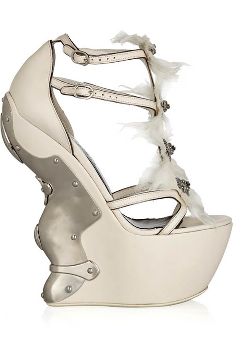 Alexander McQueen Metal-plated leather platform sandals

Open round toe, zigzag tapered wedge heel measures approximately 175mm/ 7 inches with a 60mm/ 2.5 inch platform, silver metal armor-effect plating at heel, feathered muslin flower detail and