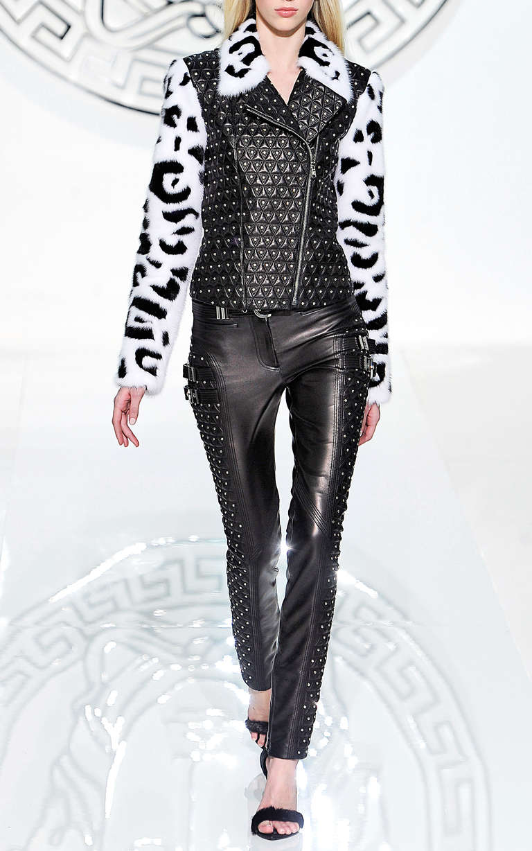 NEW VERSACE  JACKET

This studded leather moto jacket from Versace features a fur-trimmed notch collar, all-over stud detail, and full-length intarsia mink fur sleeves. 

Asymmetric front zip

100% lamb leather with 100% mink detail

Fully