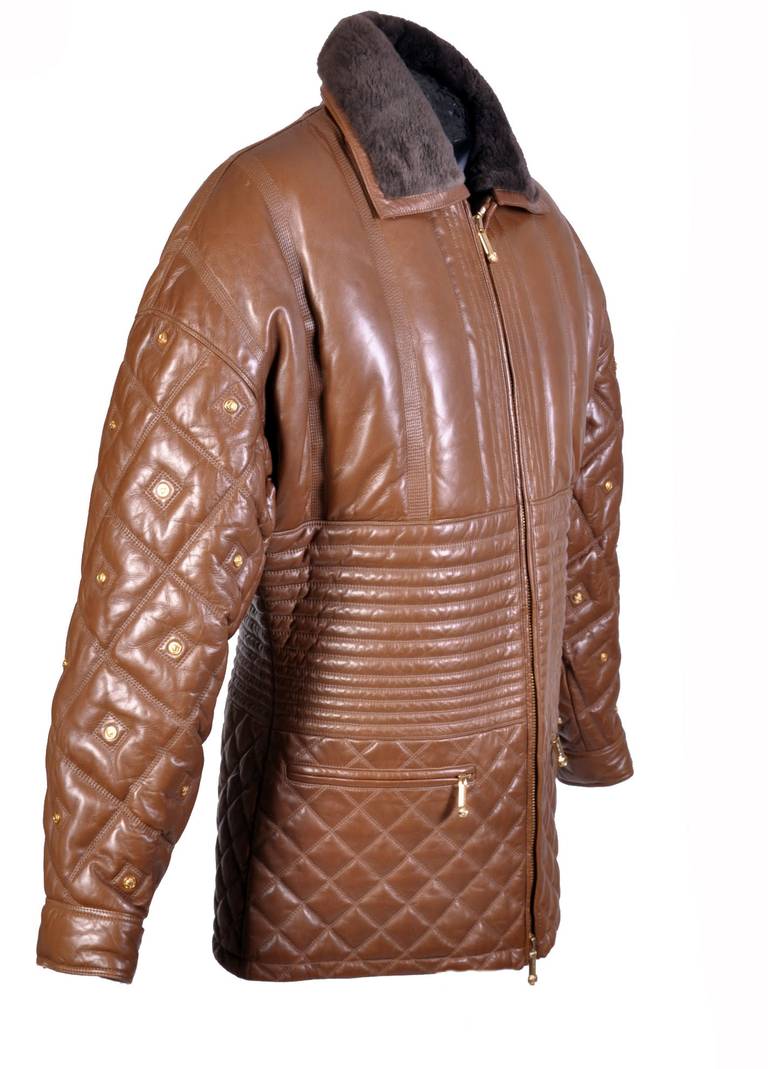 VERSACE  

Caramel brown quilted leather jacket from Versace featuring gold Medusa studs, fur collar, 

embroidered Greek Key panel under zip fastening, 

two zip pockets

and Medusa print lining.

Italian size is 48 or US 38

100%