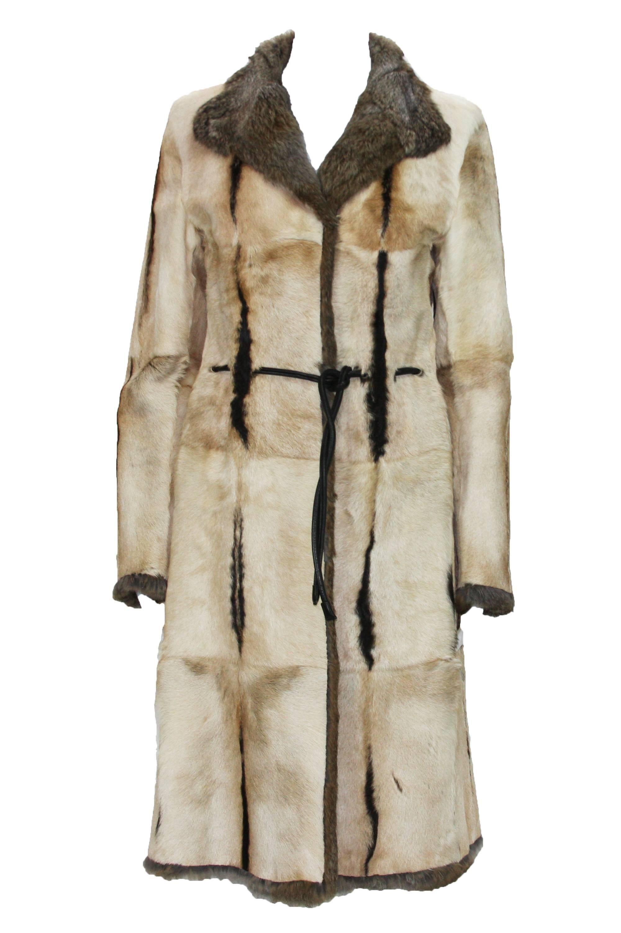 Tom Ford for Gucci Reversible Fur Coat.
1999 Collection.
 Beige color calf hair reverse to brown/gray color rabbit fur.
 Slit pockets at sides.
 Black leather tie at waist. 

Size 38

Measurements flat: length - 42 inches, shoulder - 17