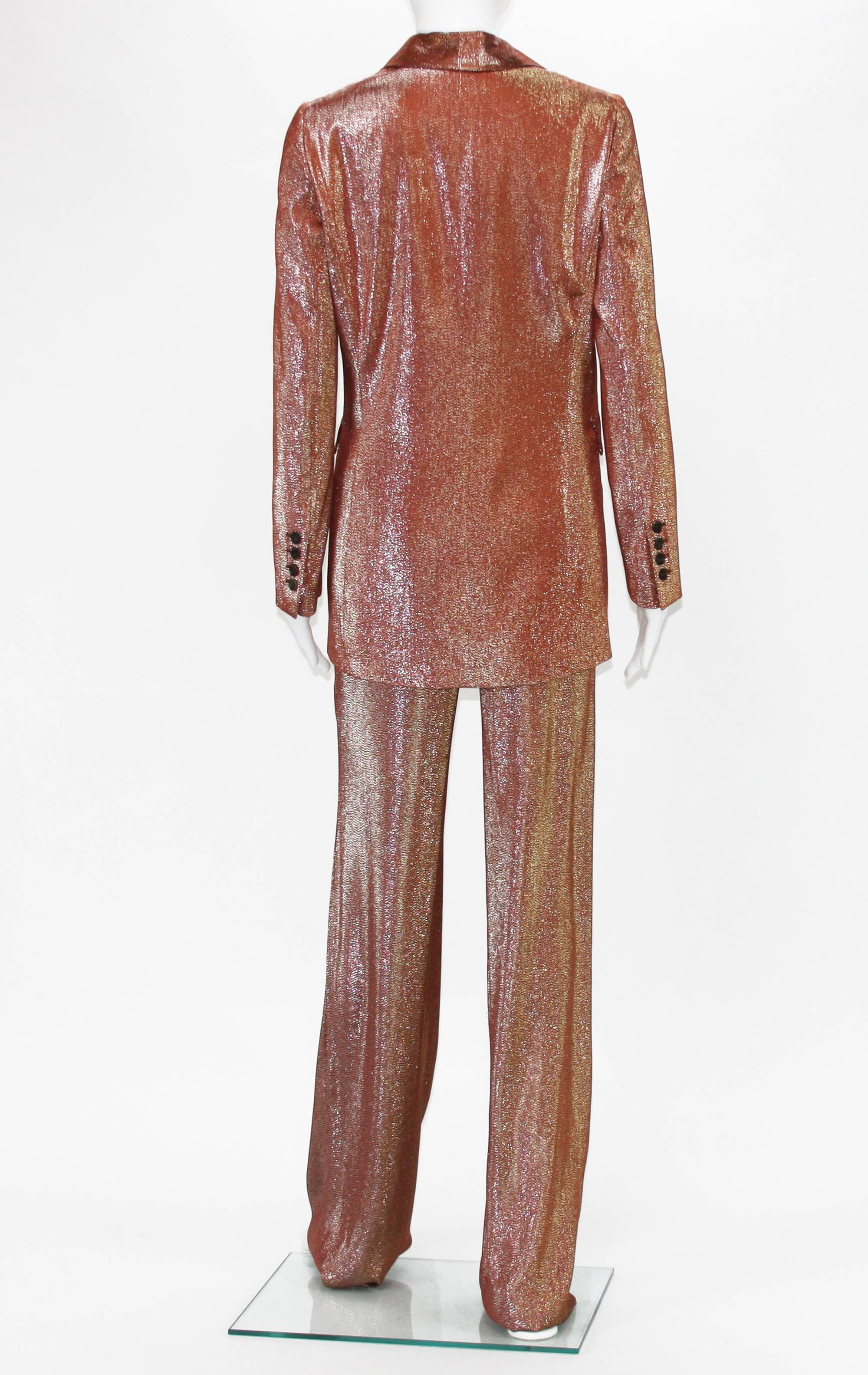 Famous style, featured on runway and in many fashion editorials.
Designer size 38.
Iridescent rust liquid lamé deconstructed jacket. Single button closure. Fabric: 43% Viscose, 39% Silk, 18% Polyester. Retail is $2,500 + tax.
Pants: Wide Leg,