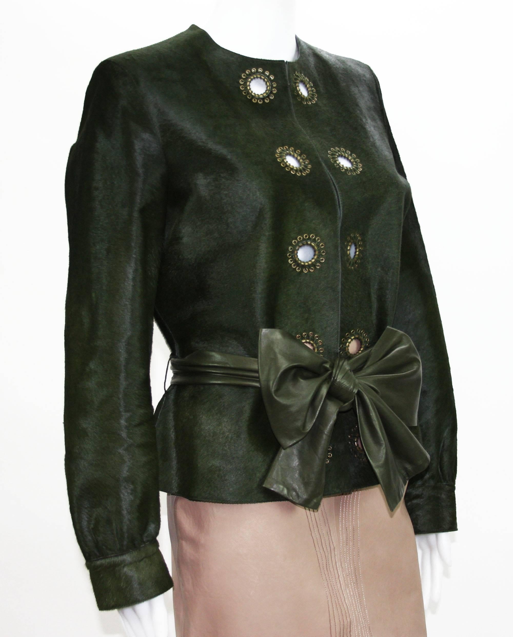 Yves Saint Laurent Leather Jacket.
Fr. size 44
100% Calf Hair.
Color - Green.
Brass-Tone Eyelet Accents Around.
Hook Closures.
Sash Tie Leather Belt.
Measurements Flat: Length - 24 inches, Sleeve - 24.5