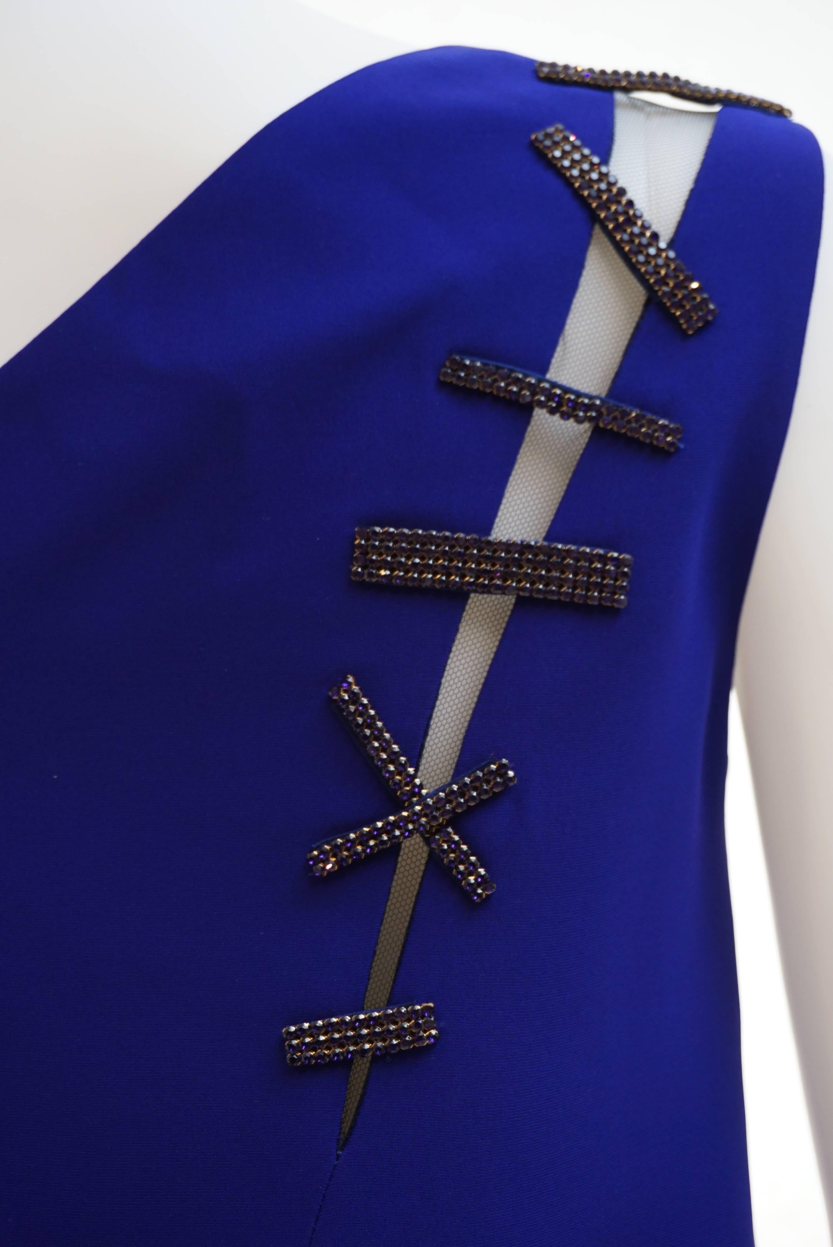 VERSACE 

Cut-out embellished crepe dress

This cobalt crepe dress is a standout creation. 

The sleek shift silhouette is slashed to reveal slices of skin, and repaired with glittering Swarovski crystal stitches. 

Fully lined

Hidden zip