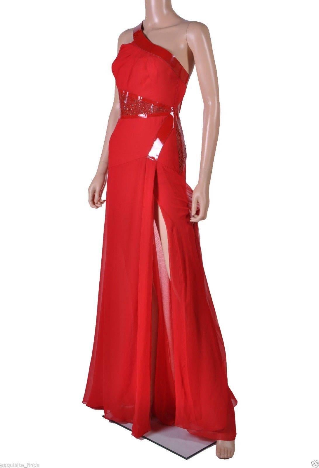  Versace

Red Chiffon Gown with Patent Leather.

One shoulder design

Laser cut detail

Thigh high slit

Made in Italy

IT Size: 38 - US 2

Brand New, with tags

