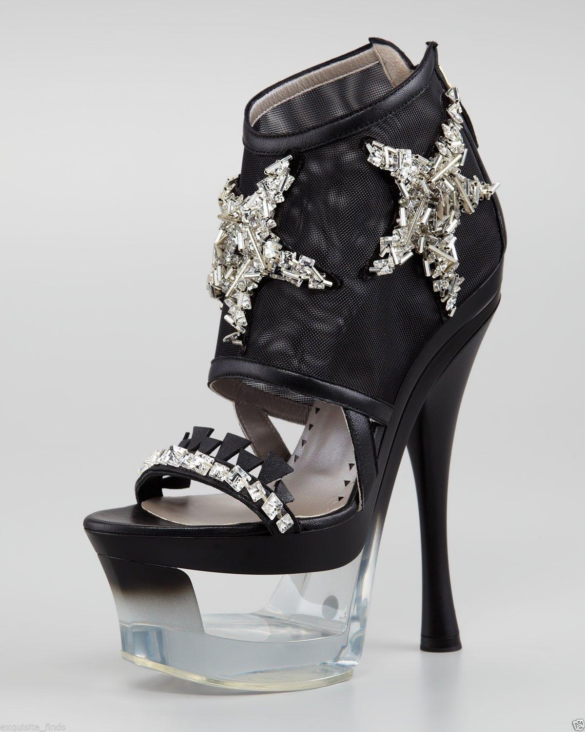 VERSACE PLATFORM SHOES

Versace heads to the sea to find inspiration for this ornate shoe. Dazzling rhinestones and a plexiglass platform speak to the brand's love of the ornate.
Mesh and lambskin upper with silver starfish beading.
6