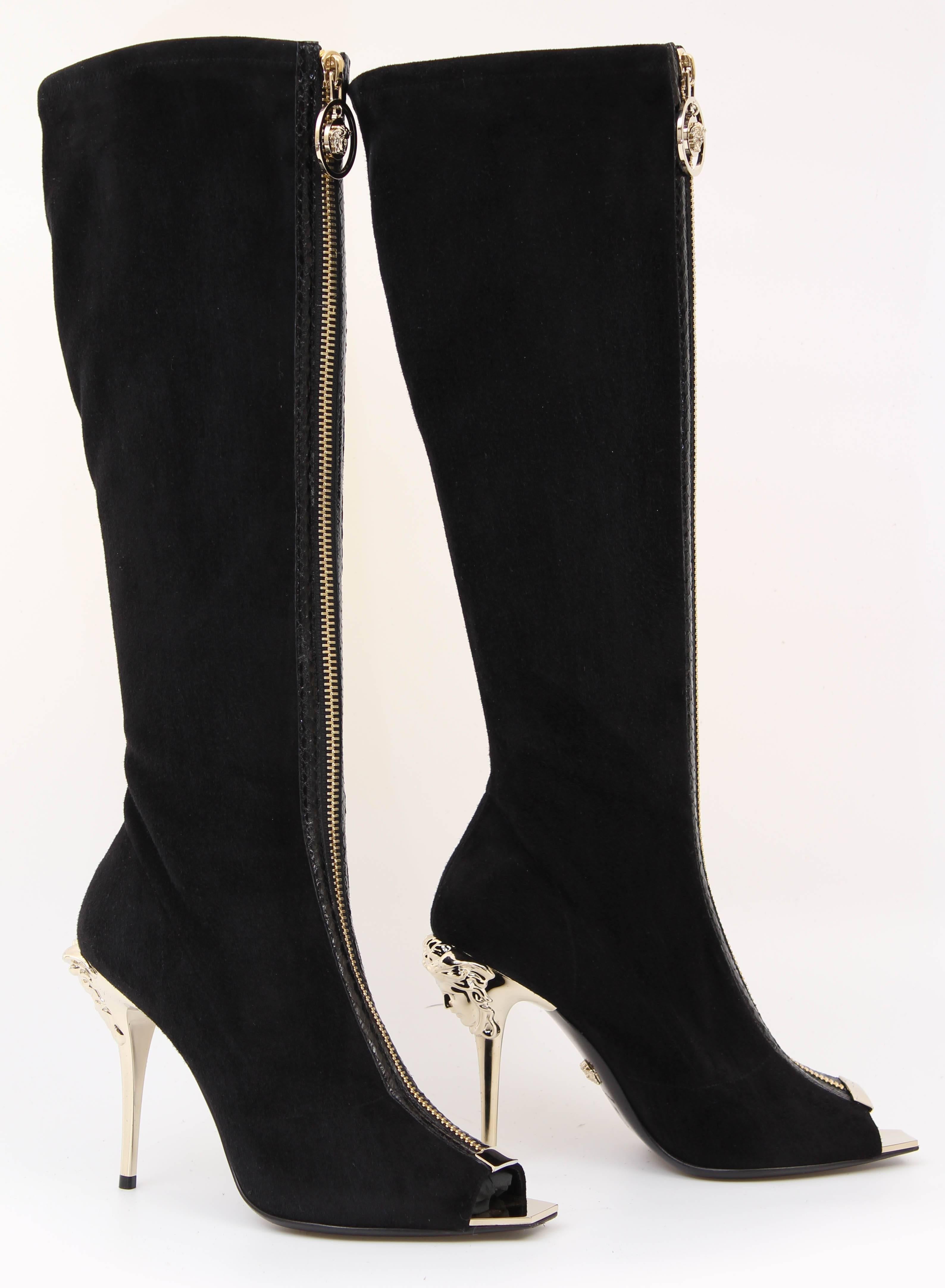 VERSACE BOOTS

These knee high suede boots are finished with open toe and gold Medusa embellished  heel.

Soft suede
Python trim detail
Stiletto heel
100% leather
Made in Italy

IT Size 36

New, in the box. 

