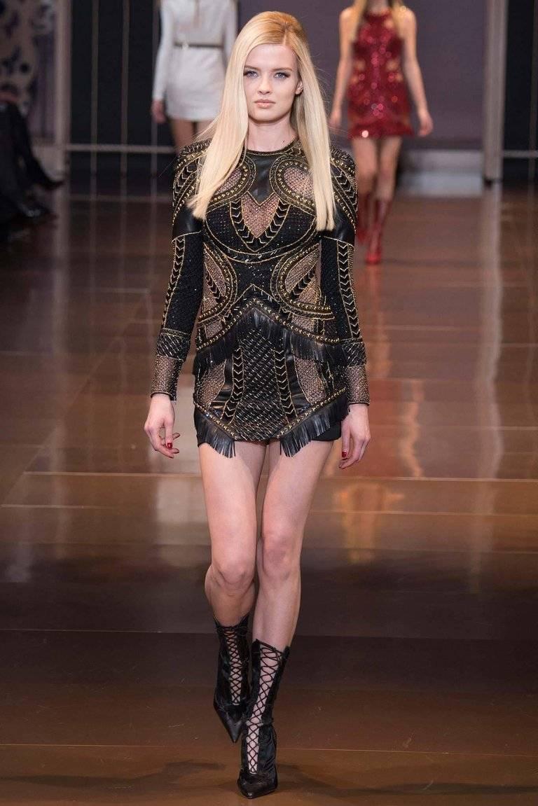 VERSACE 

Breathtaking Embellished Leather Dress

Impossible to find!!!

Crafted in Italy from soft black leather, this figure-hugging mini dress is embellished with gold studs, crystals, beads, chains and fringe that are thoughtfully placed to