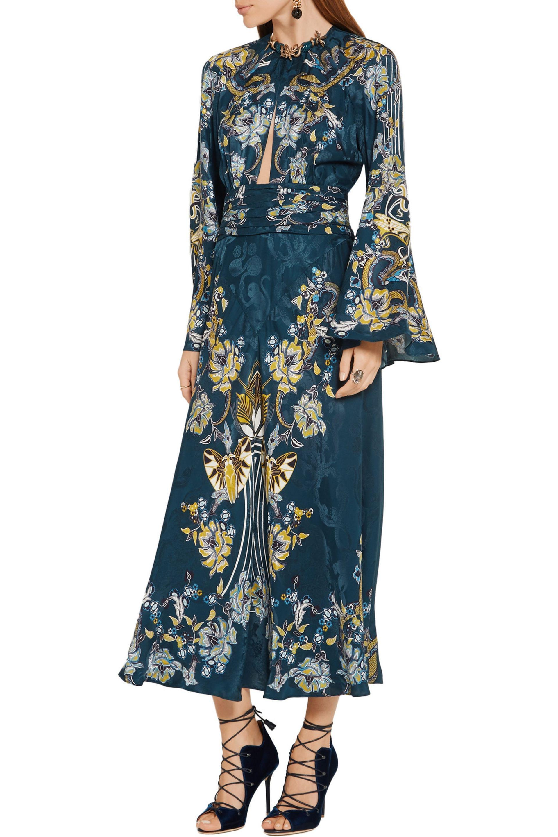 Roberto Cavalli 

Stunning gown with embellishments around the neck.

52% viscose , 48% silk
Made in Italy
Unlined
Front and back keyhole with button closures
Engraved metal charm detail at neckline
Hidden back zip closure
Bell sleeves with slit