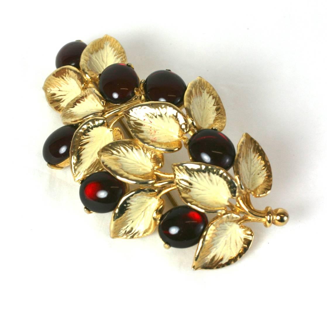 Schiaparelli's lovely garnet pate de verre cabochon naturalistic berry branch brooch. Of gilt metal and ivory colored cold enamel. Excellent Condition, Length 3.50