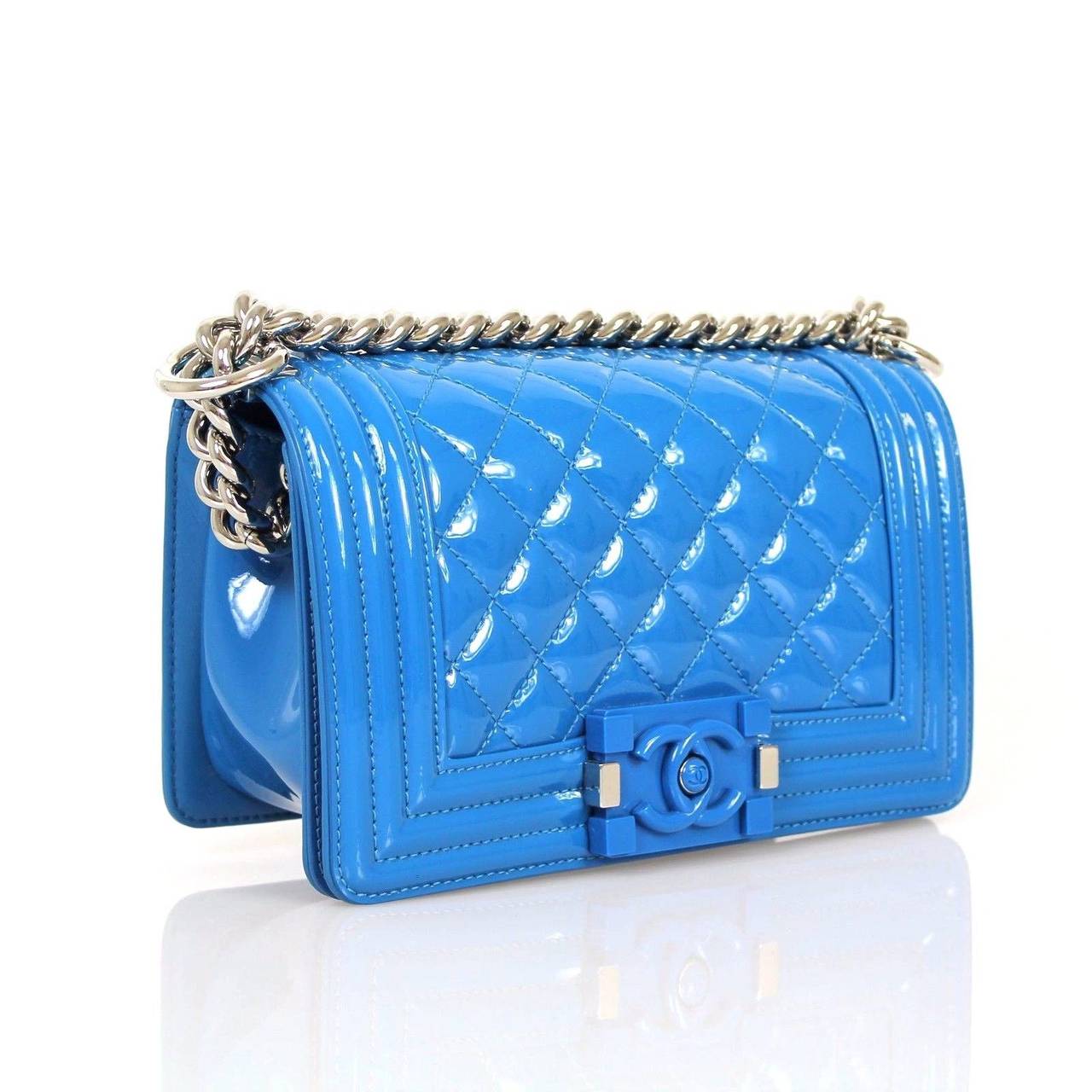 Chanel Patent Boy Bags for the Cruise 2015 Collection. The boy is made in a very shiny patent leather in royal blue candy color with a plexi glass closure and silver hardware. The exterior almost gives it a synthetic look to the otherwise leather